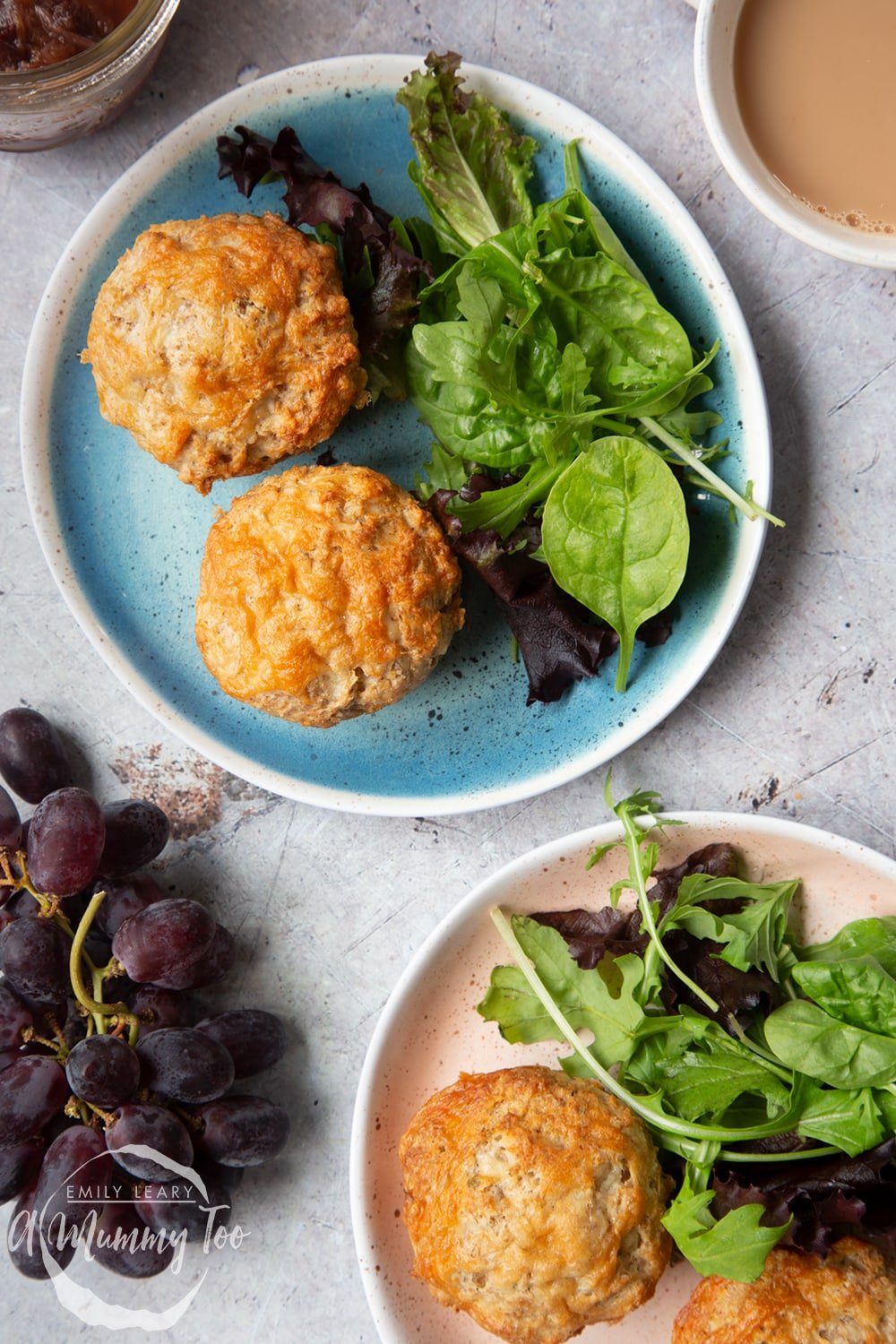 Easy cheese muffins served to two plates with leafy salad. 