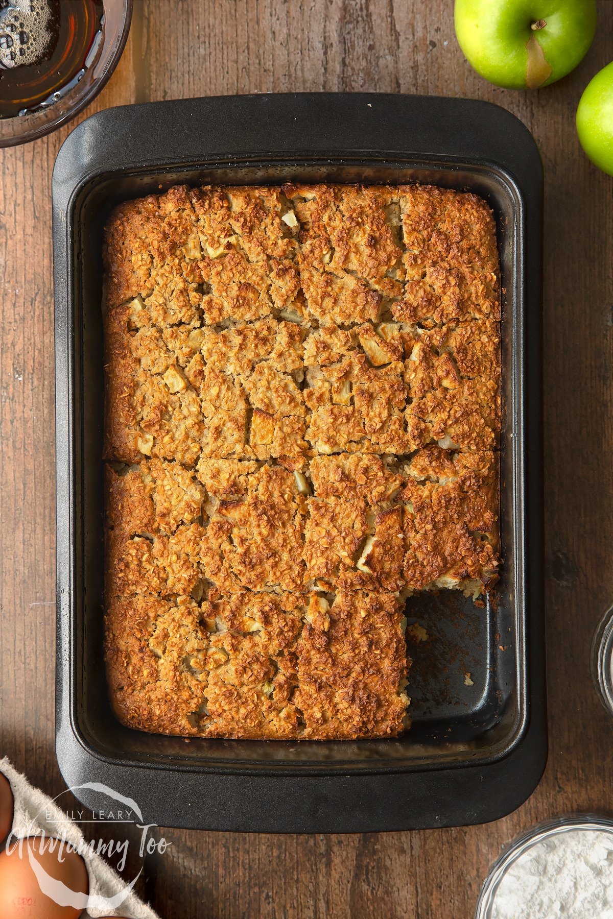 Freshly baked porridge squares cut into 16 pieces. One piece has been taken away.