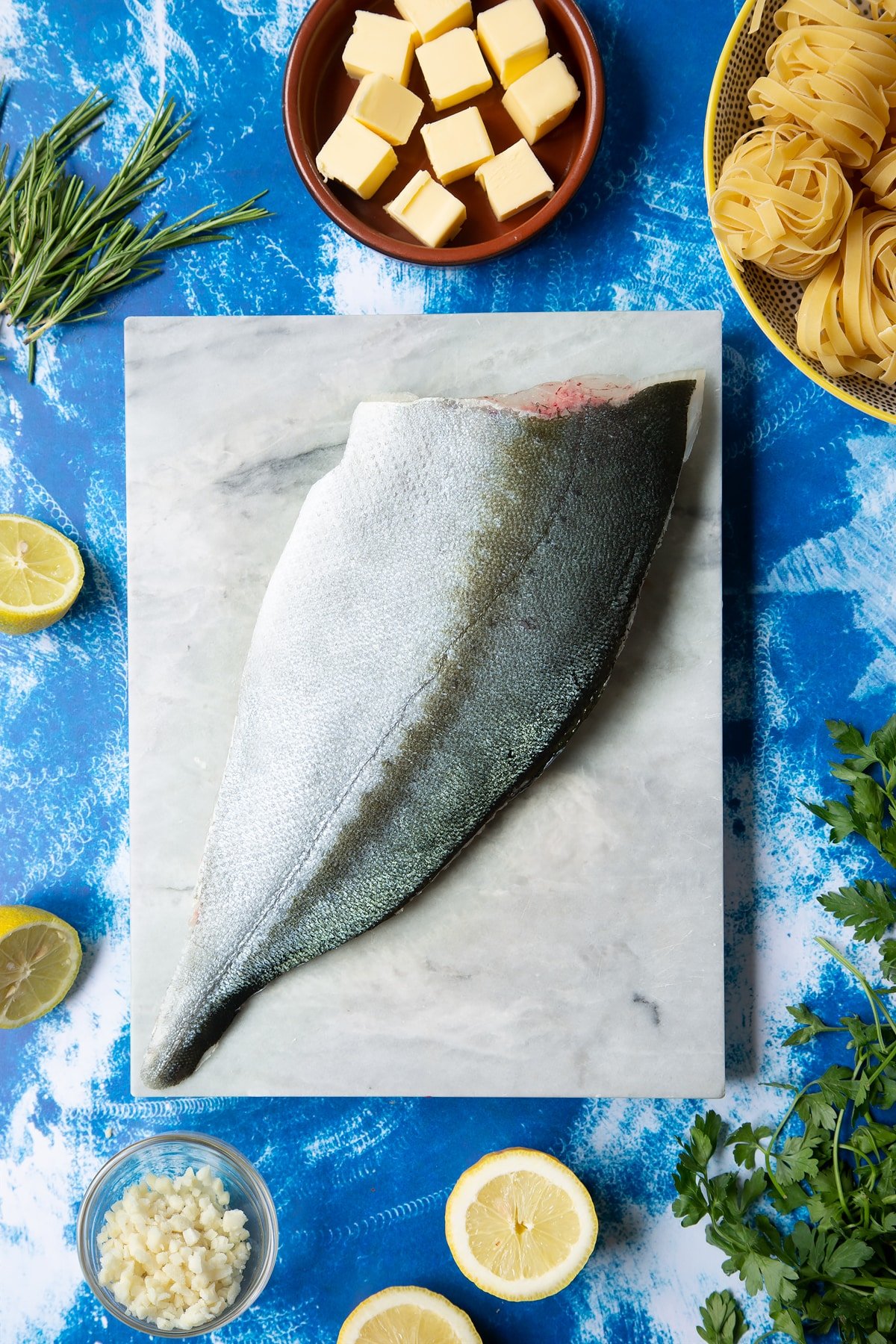 A Dutch Yellowtail fillet on a marble board, skin side up