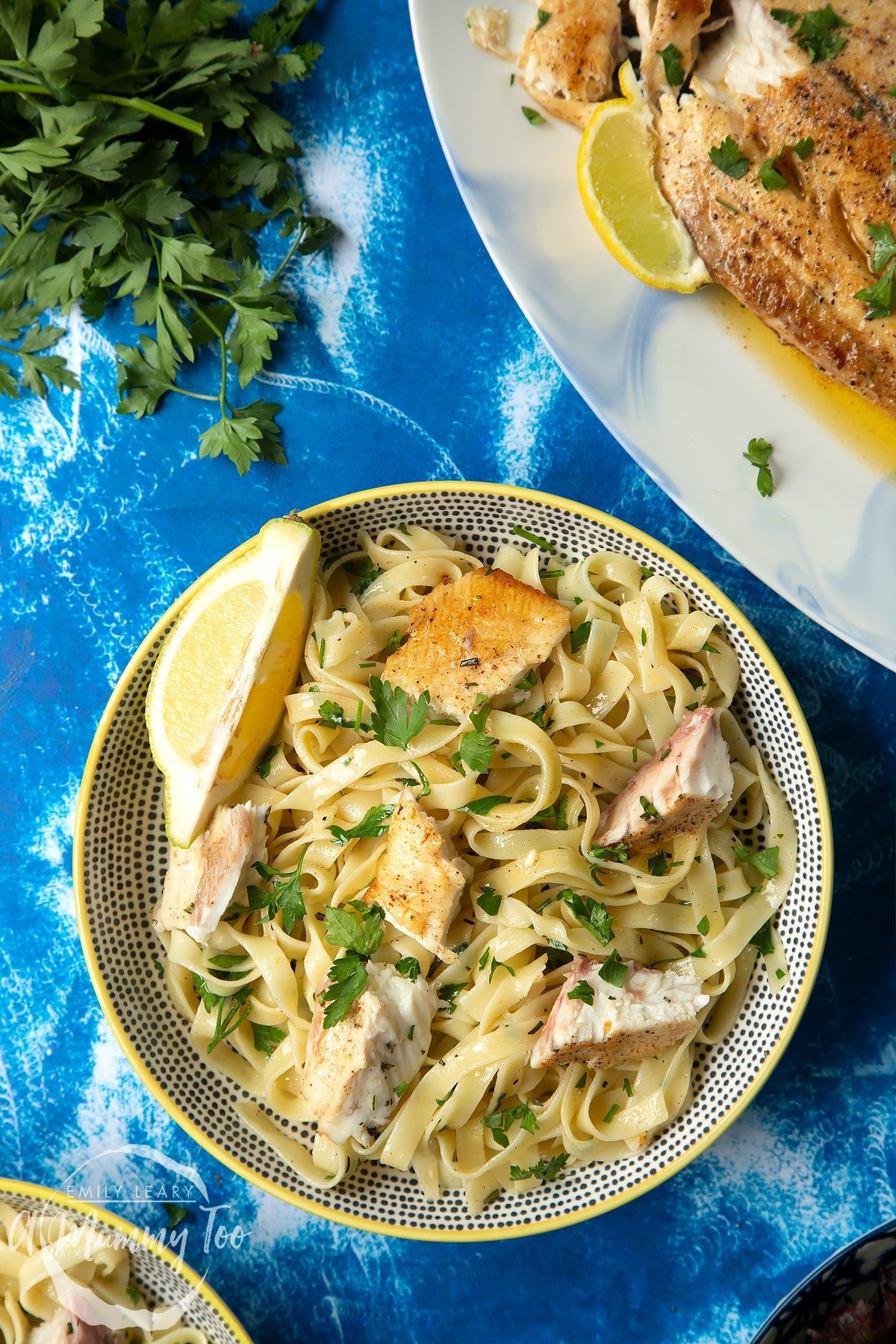 Pan-fried Yellowtail tagliatelle served in a wide, shallow bowl.