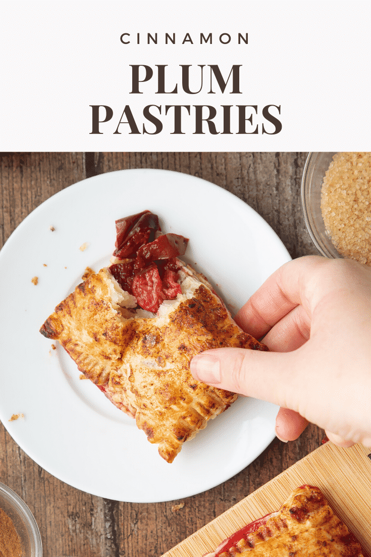 A hand picking up a plum pastry from a white plate. Caption reads: cinnamon plum pastries 