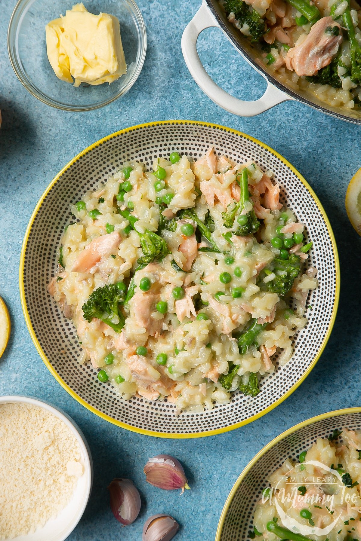 Salmon risotto in a spotted bowl with a yellow rim.
