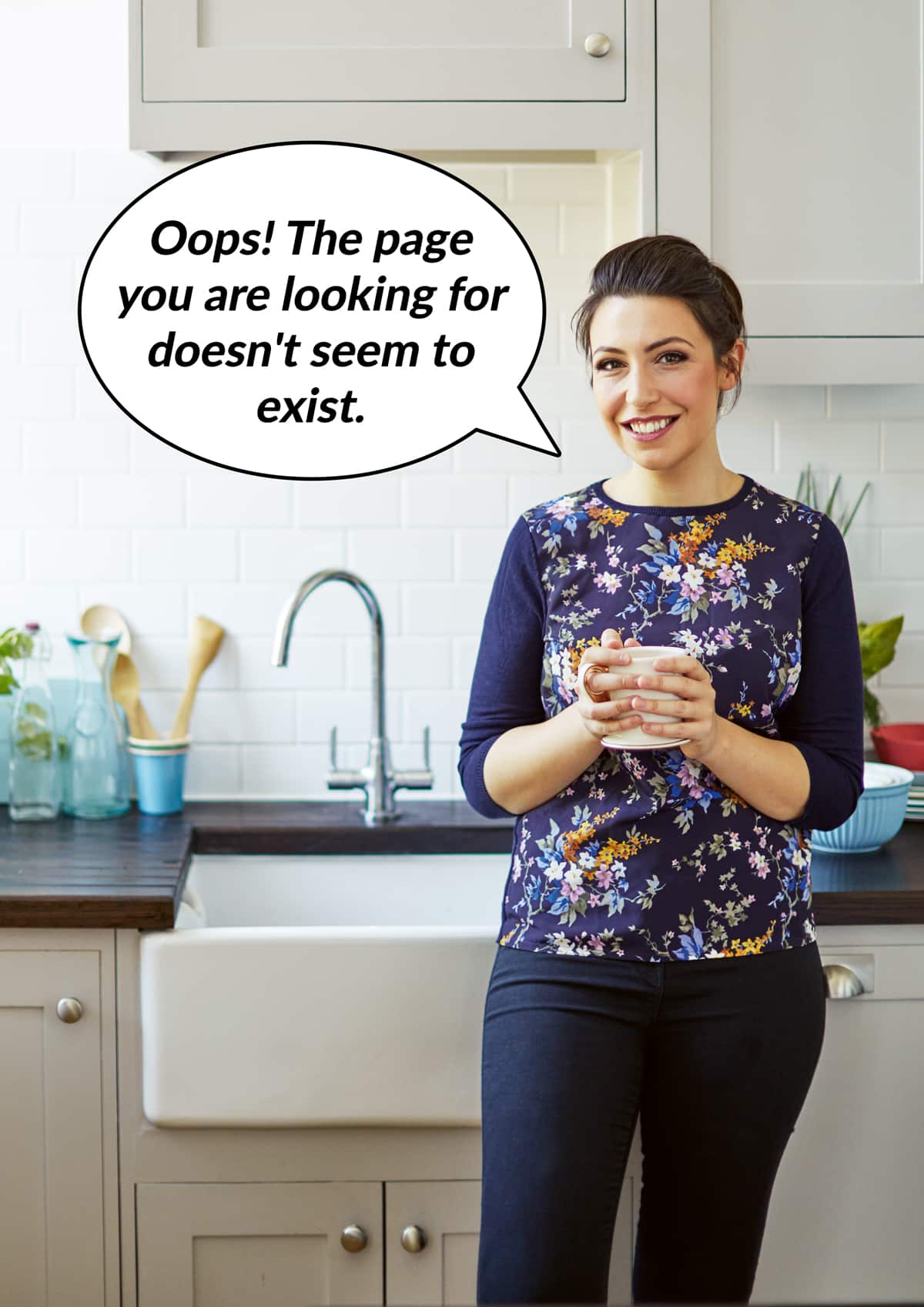 Woman leaning against a worktop in a kitchen. A speech bubble reads, "Oops! The page you are looking for doesn't seem to exist."