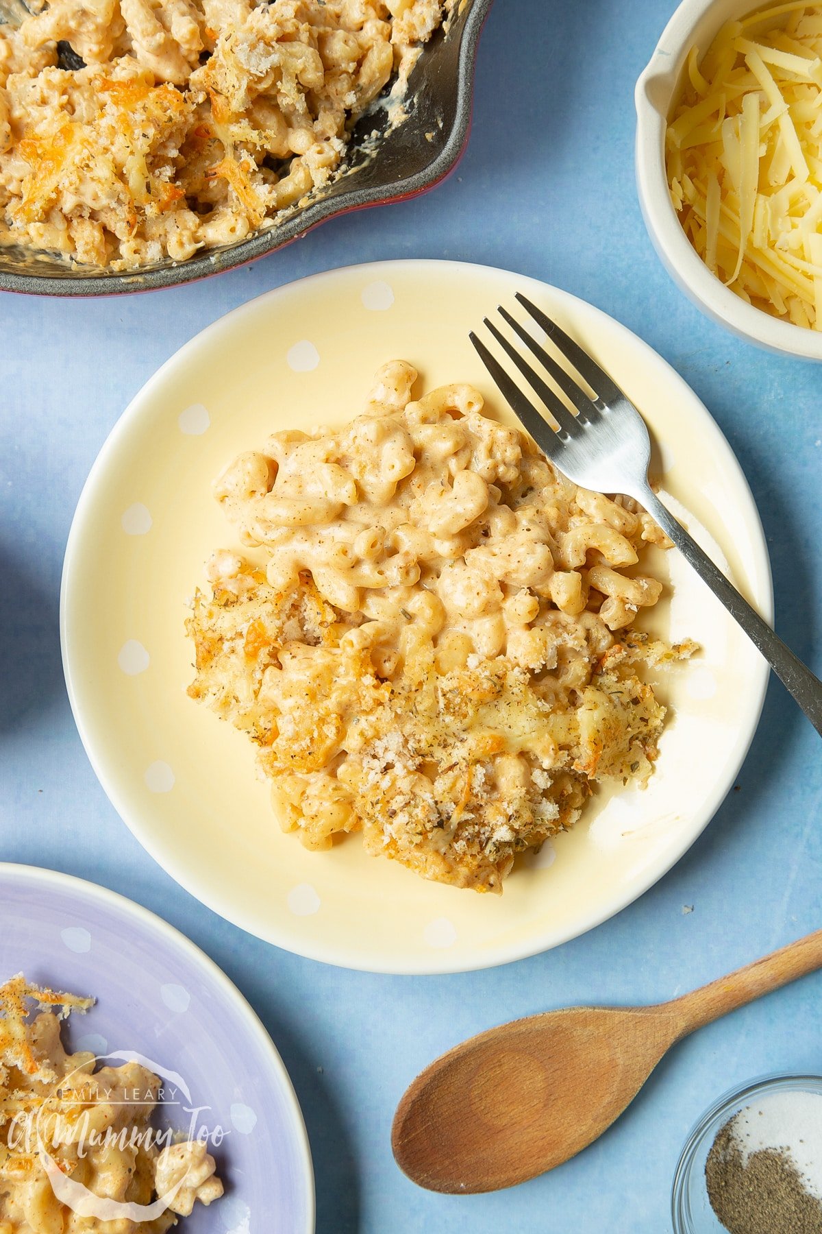 Garlic and herb mac and cheese on a yellow spotty plate with a fork.