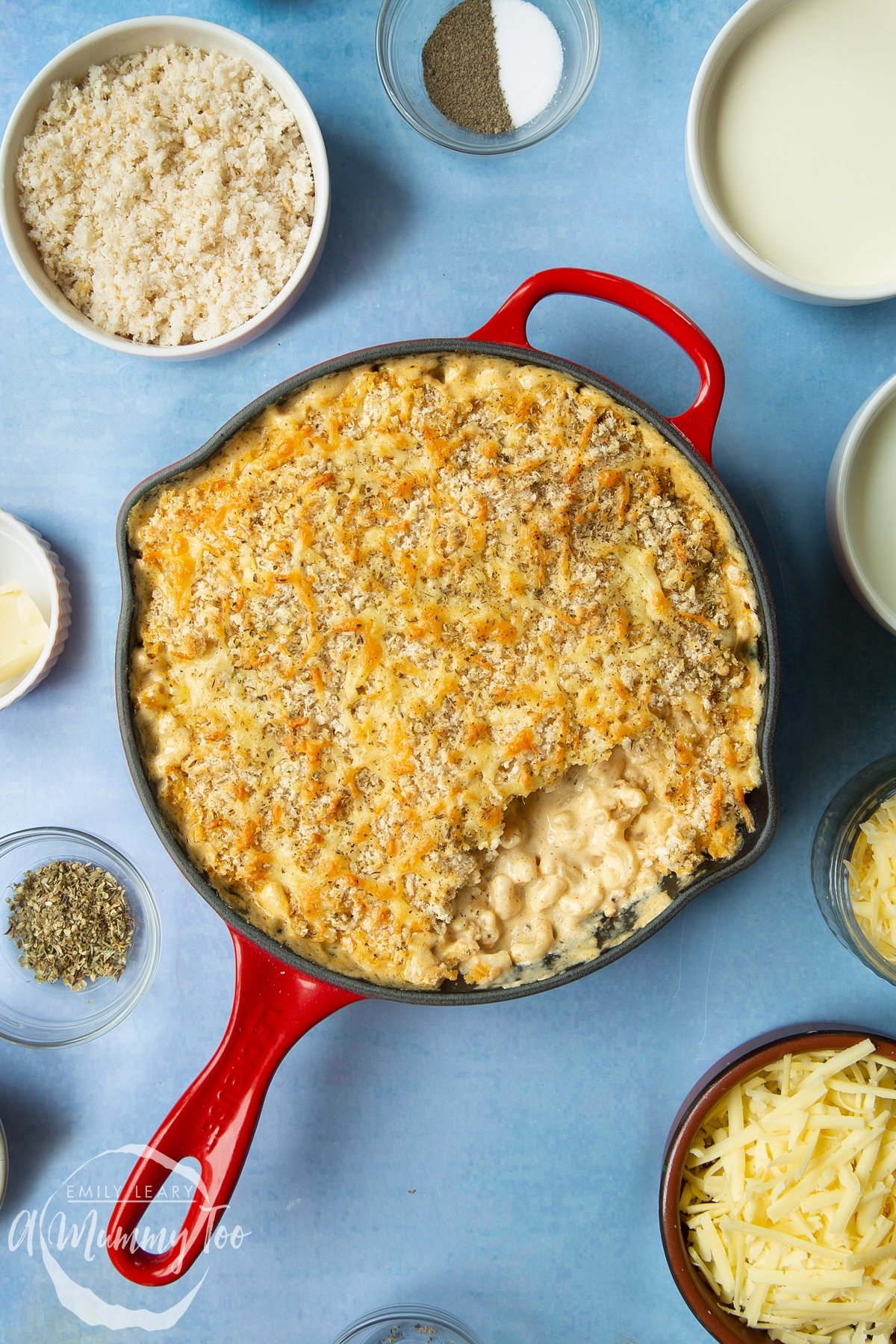 Freshly baked garlic and herb mac and cheese in a skillet. Some of the pasta has been served.