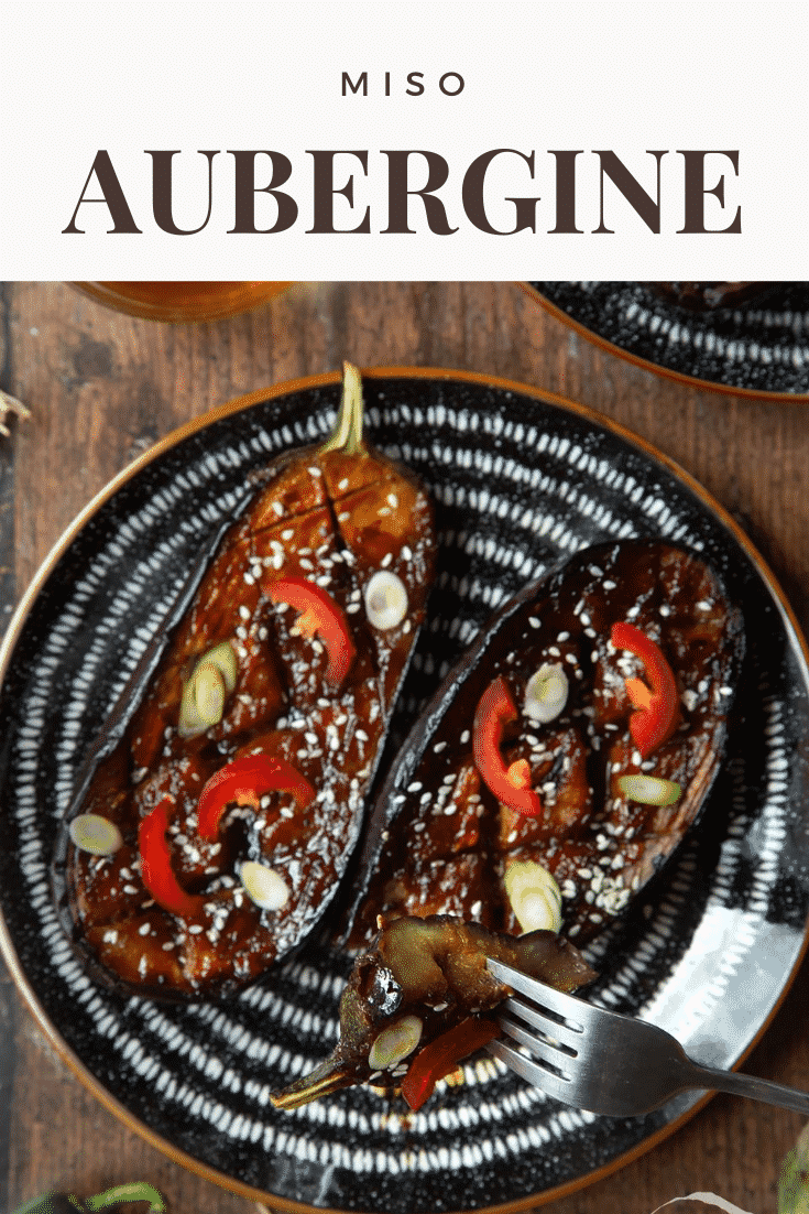 Two slices of miso aubergine on a plate, topped with chilli, springs onions and sesame seeds. Caption reads: miso aubergine