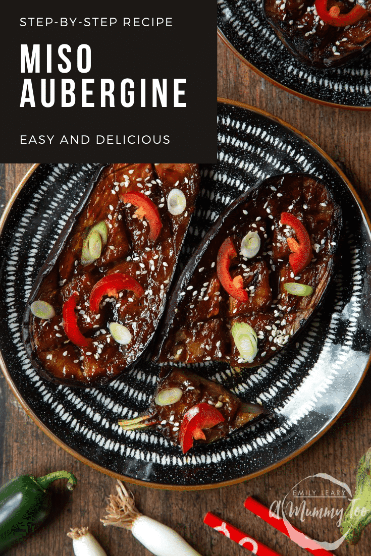 Two slices of miso aubergine on a plate, topped with chilli, springs onions and sesame seeds. One piece has been sliced. Caption reads: step-by-step recipe miso aubergine easy and delicious