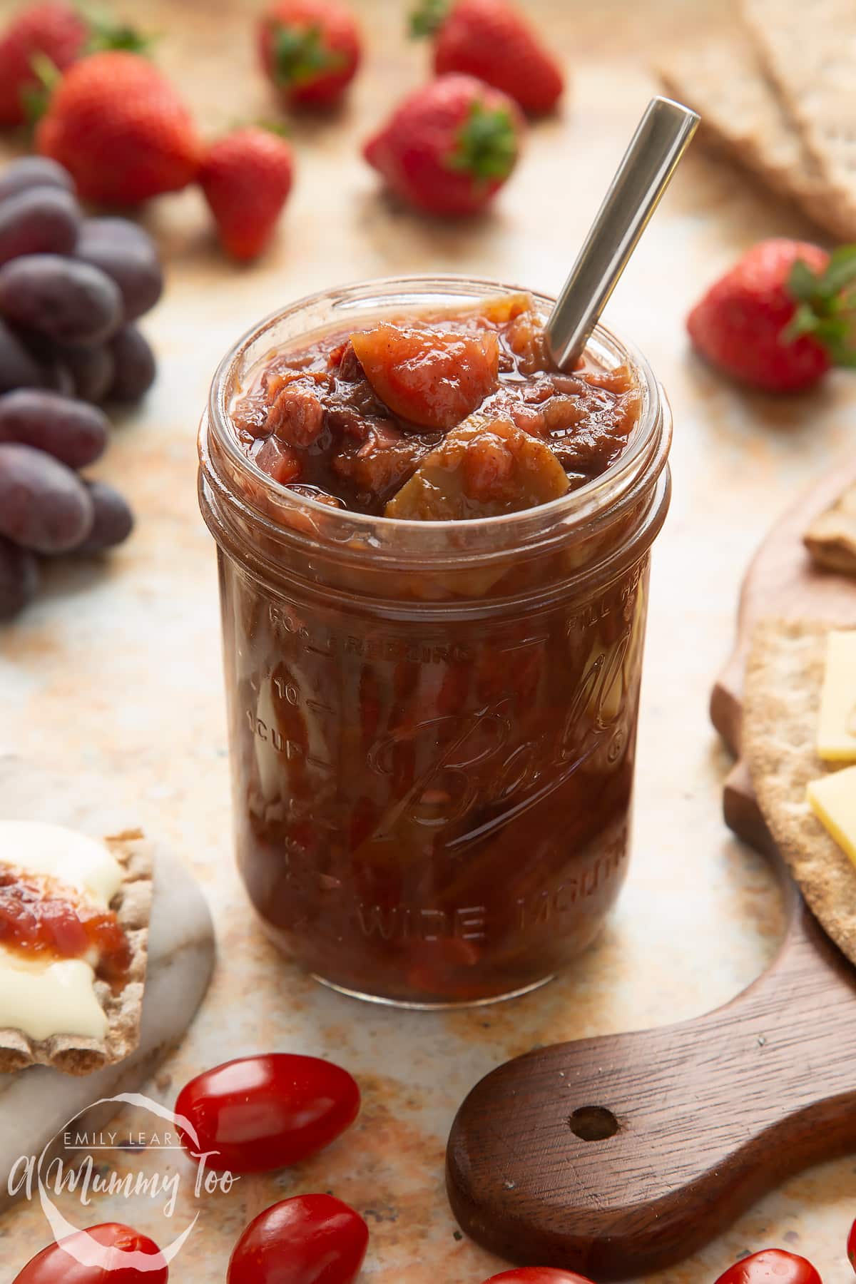 Fruit chutney recipe in a jar with a spoon.