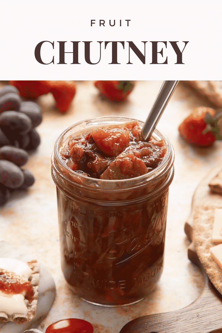 Fruit chutney recipe in a jar with a spoon. Caption reads: fruit chutney