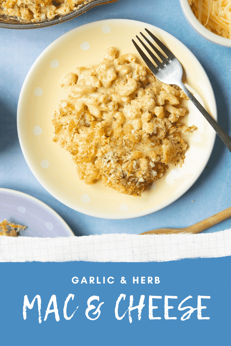 A portion of garlic and herb mac and cheese and a spotty yellow plate with a fork. Caption reads: garlic & herb mac & cheese