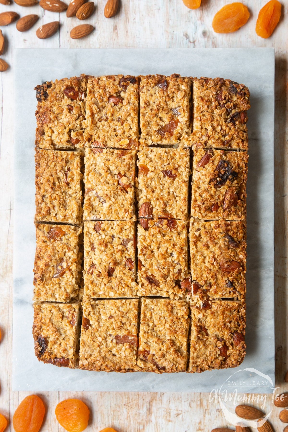 Overhead shot of sliced Apricot oat served in a marble slab with a mummy too logo in the lower-right corner