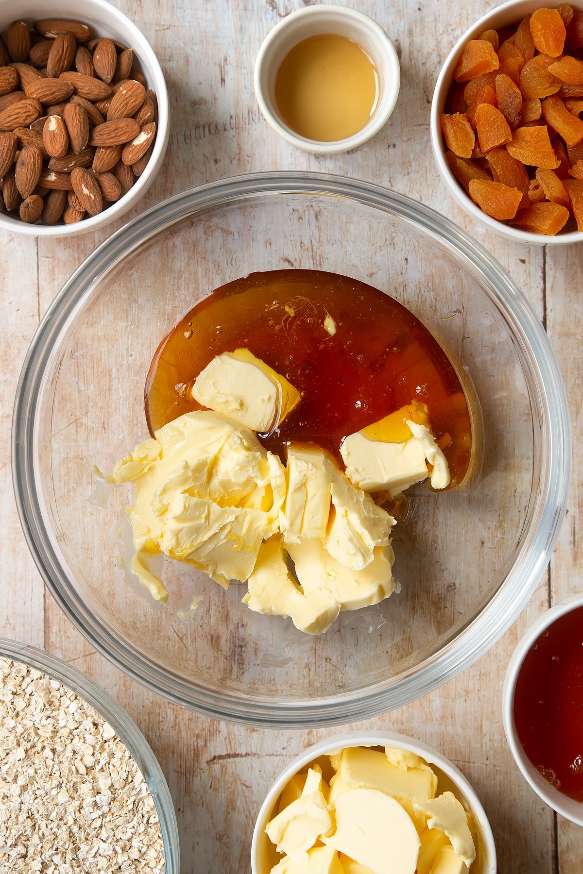 Overhead shot of butter, vanilla and syrup in a large clear bowl