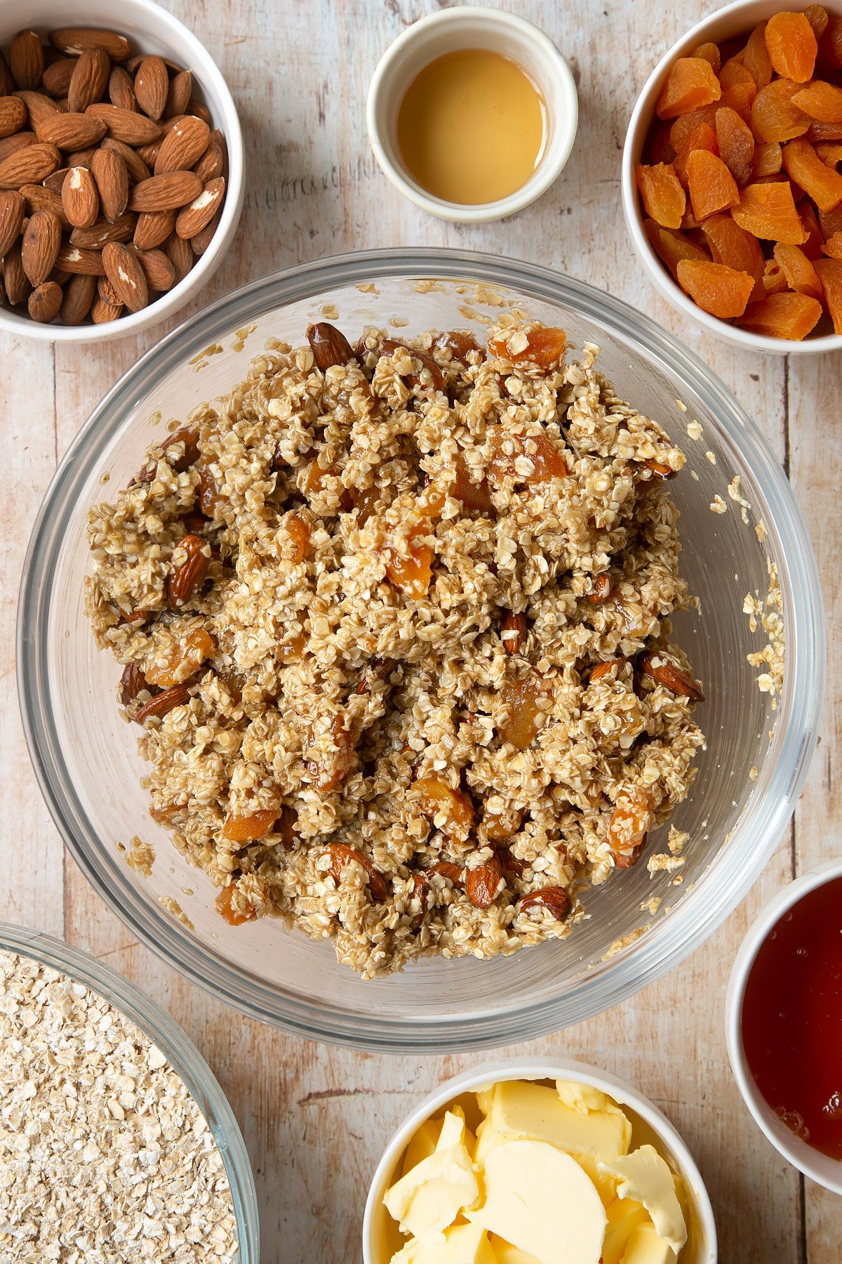 Overhead shot of oat mixture in a large clear bowl