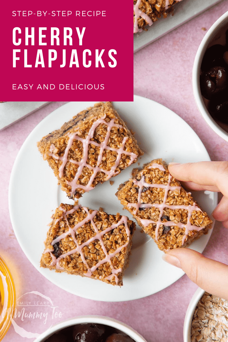 Overhead shot of a hand holding a cherry flapjack