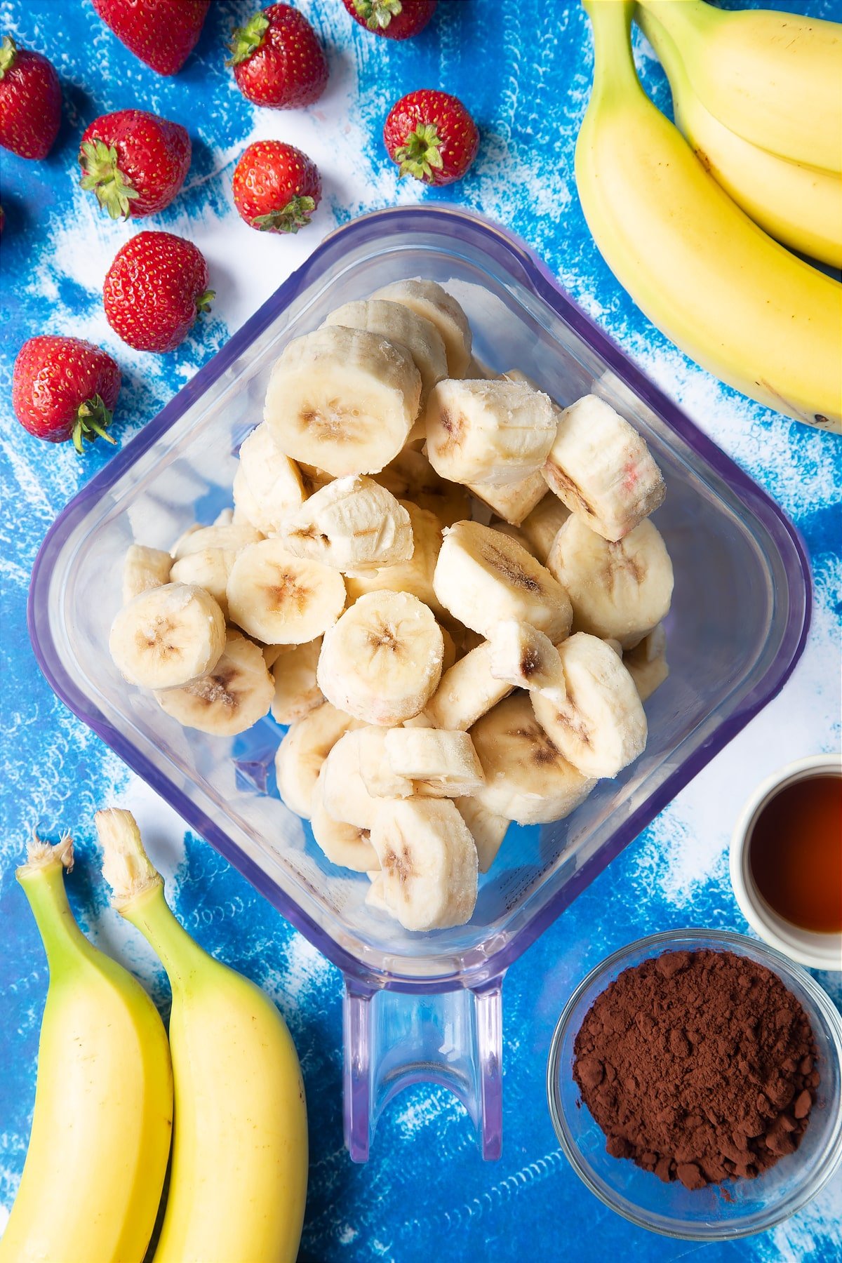 Frozen sliced bananas in a blender.