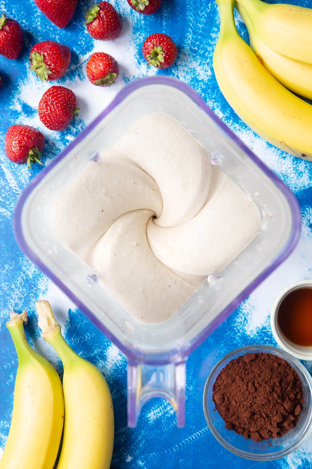 Pureed frozen bananas in a blender.