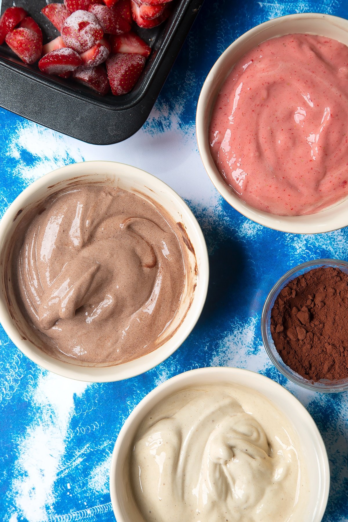 Banana ice cream in three bowls - one chocolate, one vanilla and one strawberry.