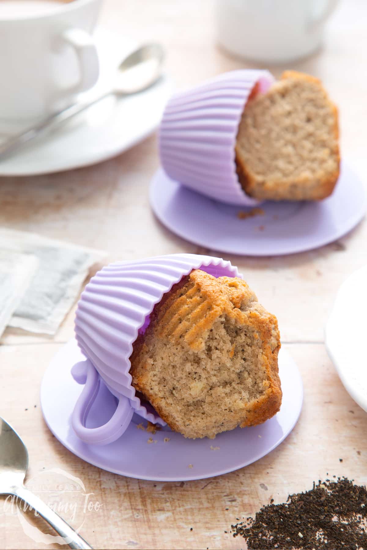 Overhead shot of half-eaten Earl Grey cupcakes served on a silicone casing with a mummy too logo in the lower-left corner