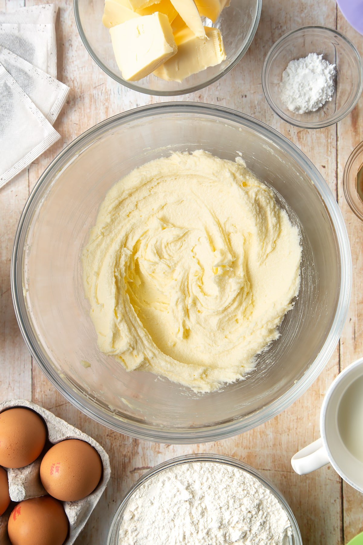 Overhead shot of mixed butter in a large clear bowl