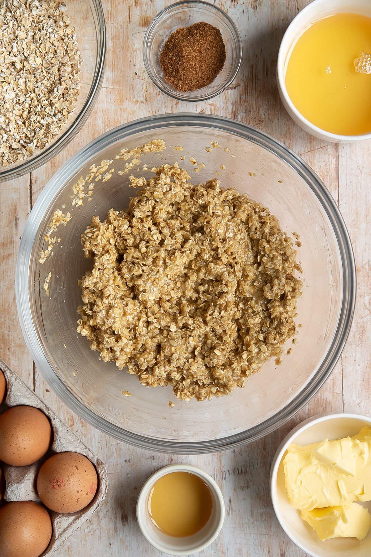 Overhead shot of oat bars mix in a large clear bowl