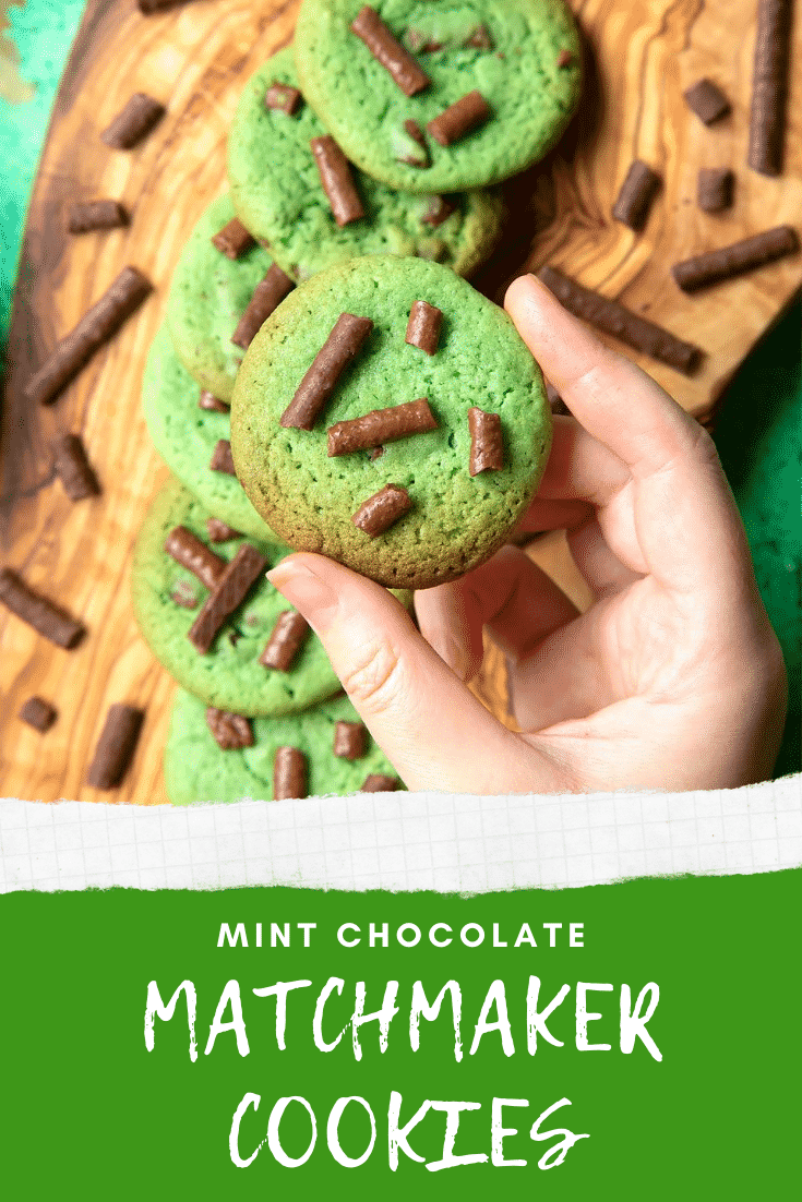 Hand holding a Matchmaker cookie above more cookies arranged on a wooden board. Caption reads: Mint chocolate Matchmaker cookies