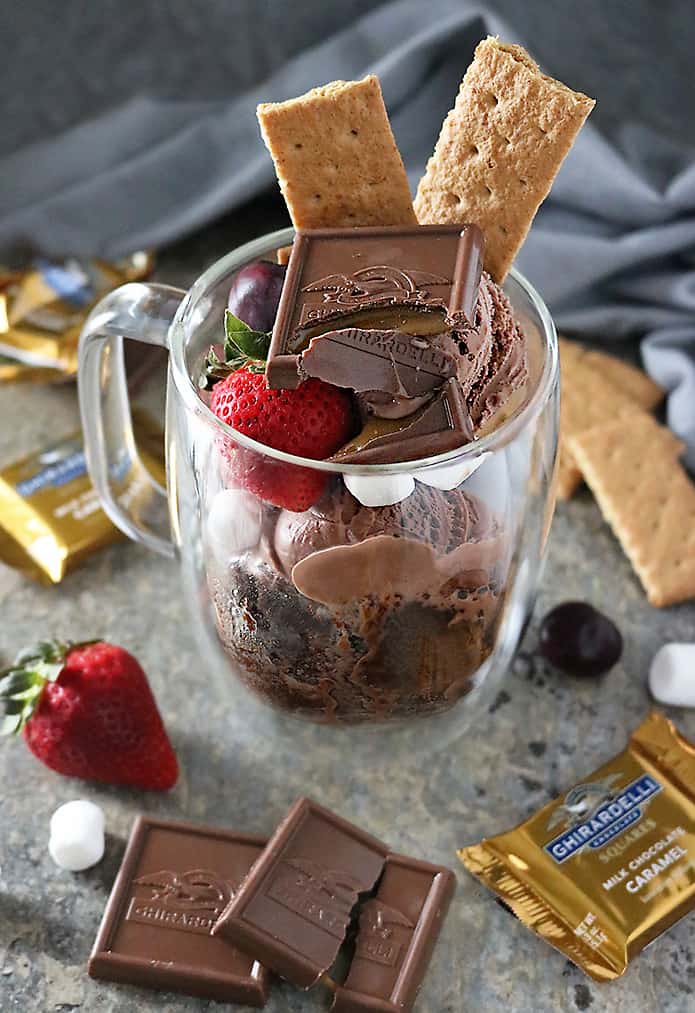 Chocolate caramel s’mores mug cake - chocolate cake cooked in a mug and then served with crackers, chocolate and marshmallows.