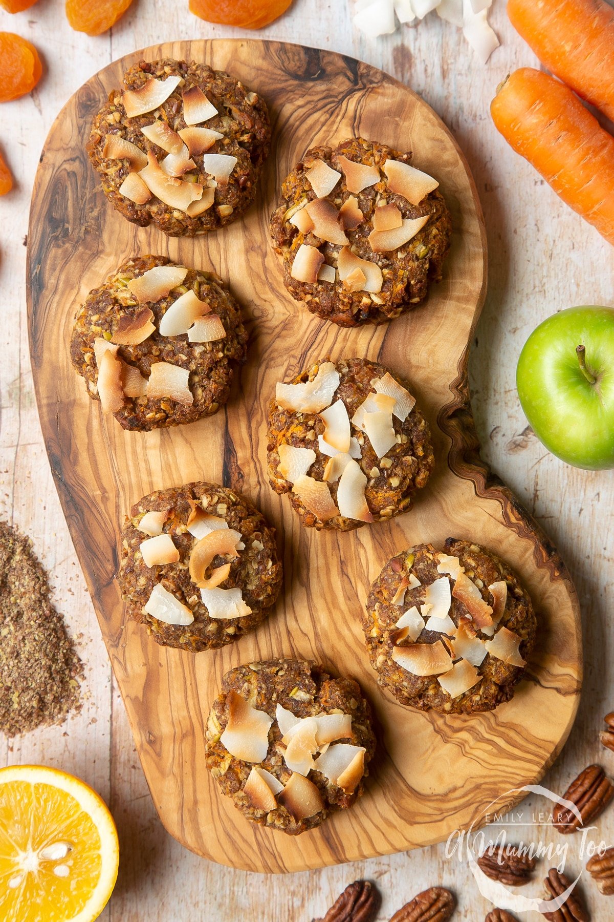 Front angle shot of Superfood breakfast cookies served on a wooden plate with a mummy too logo in the lower-left corner