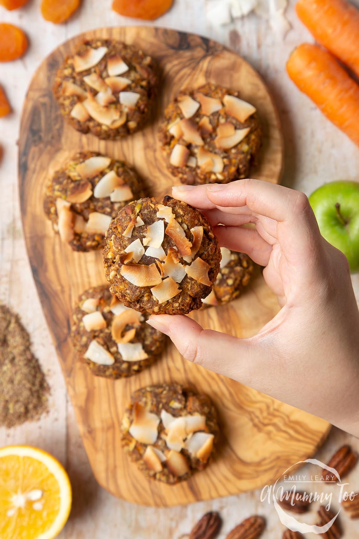 Overhead shot of flour, oats, baking powder, ginger and cinnamon in a large clear bowl