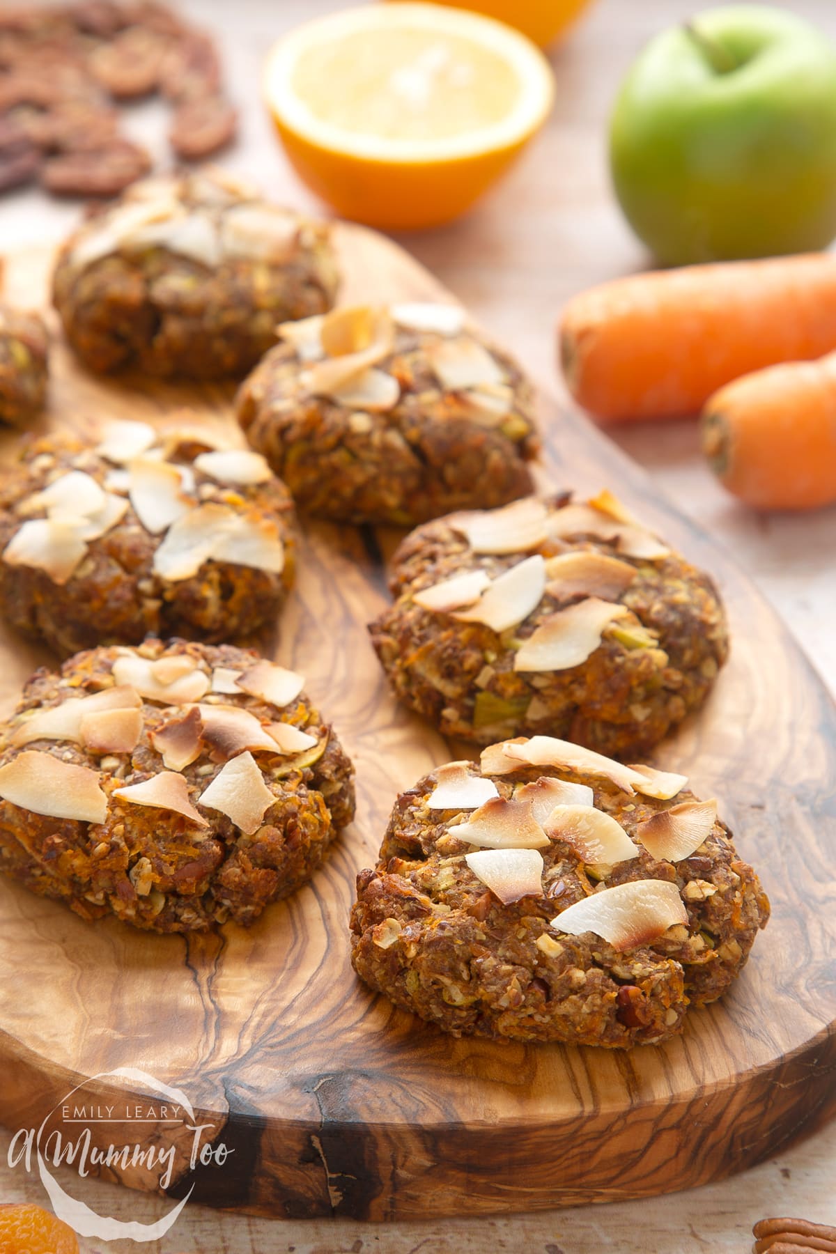 Front angle shot of Superfood breakfast cookies served on a wooden plate with a mummy too logo in the lower-left corner