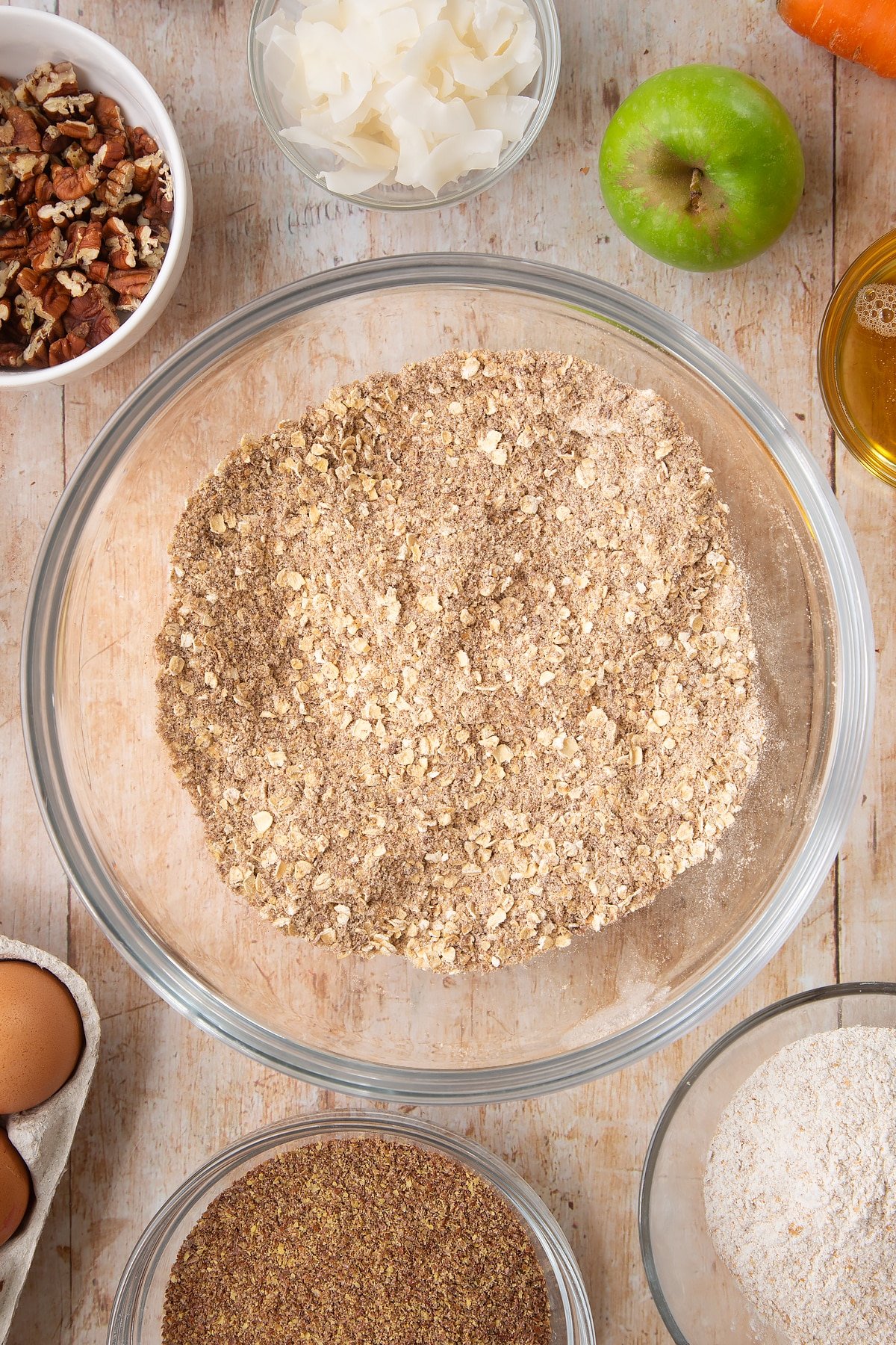 Overhead shot of dry ingredients mix in a large clear bowl