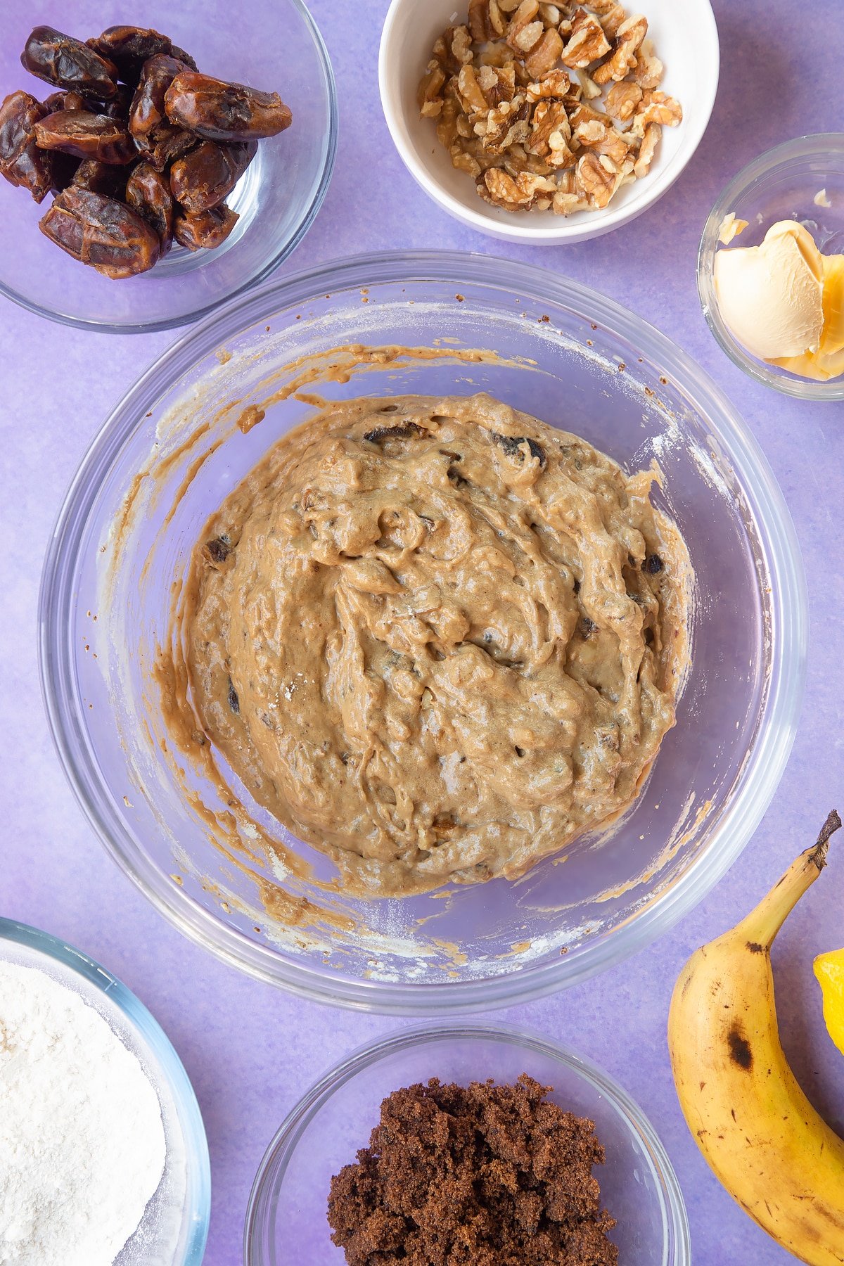 Overhead shot of fruit mixture and flour in a large bowl