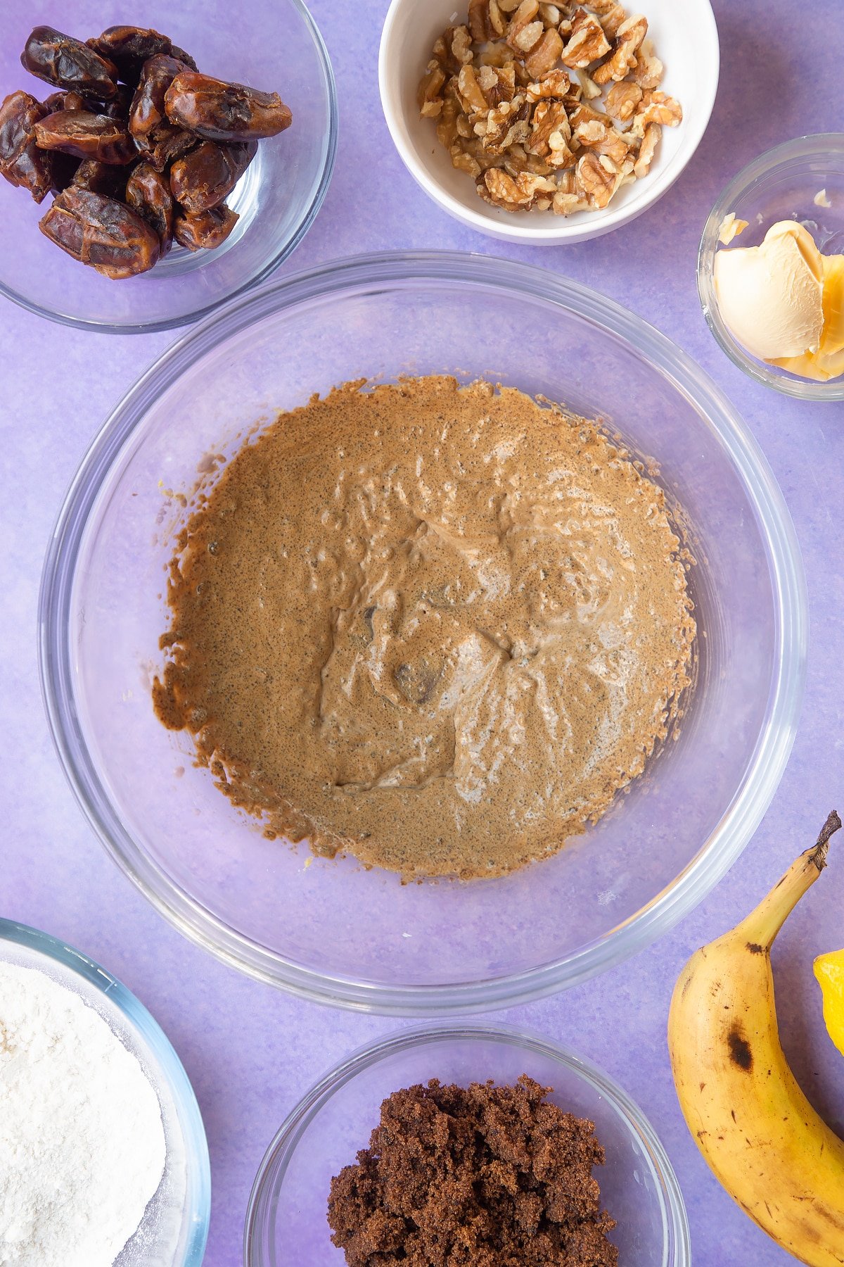 Overhead shot of margarine and sugar in a large clear bowl