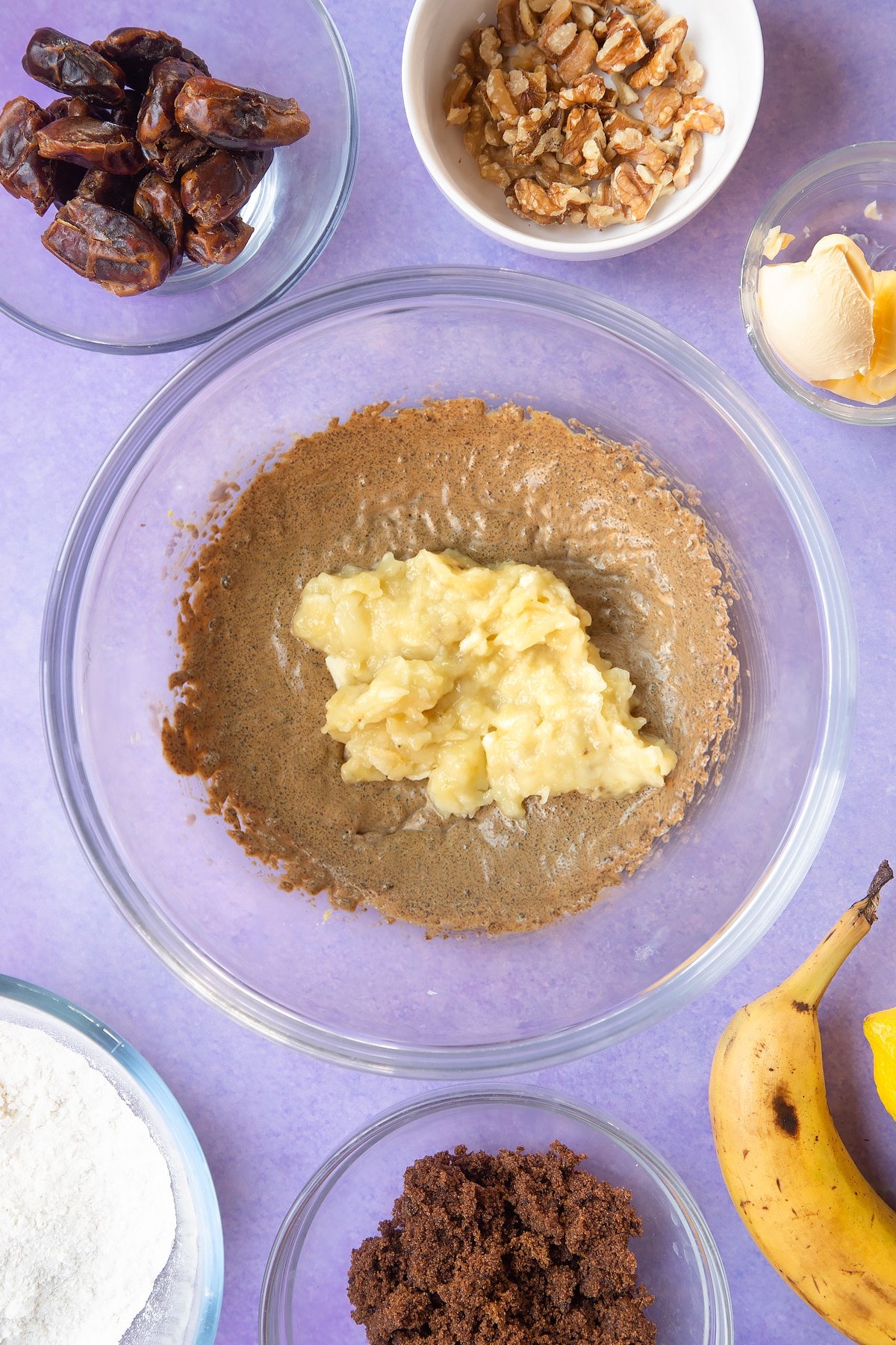 Overhead shot of whipped margarine and sugar in a large clear bowl