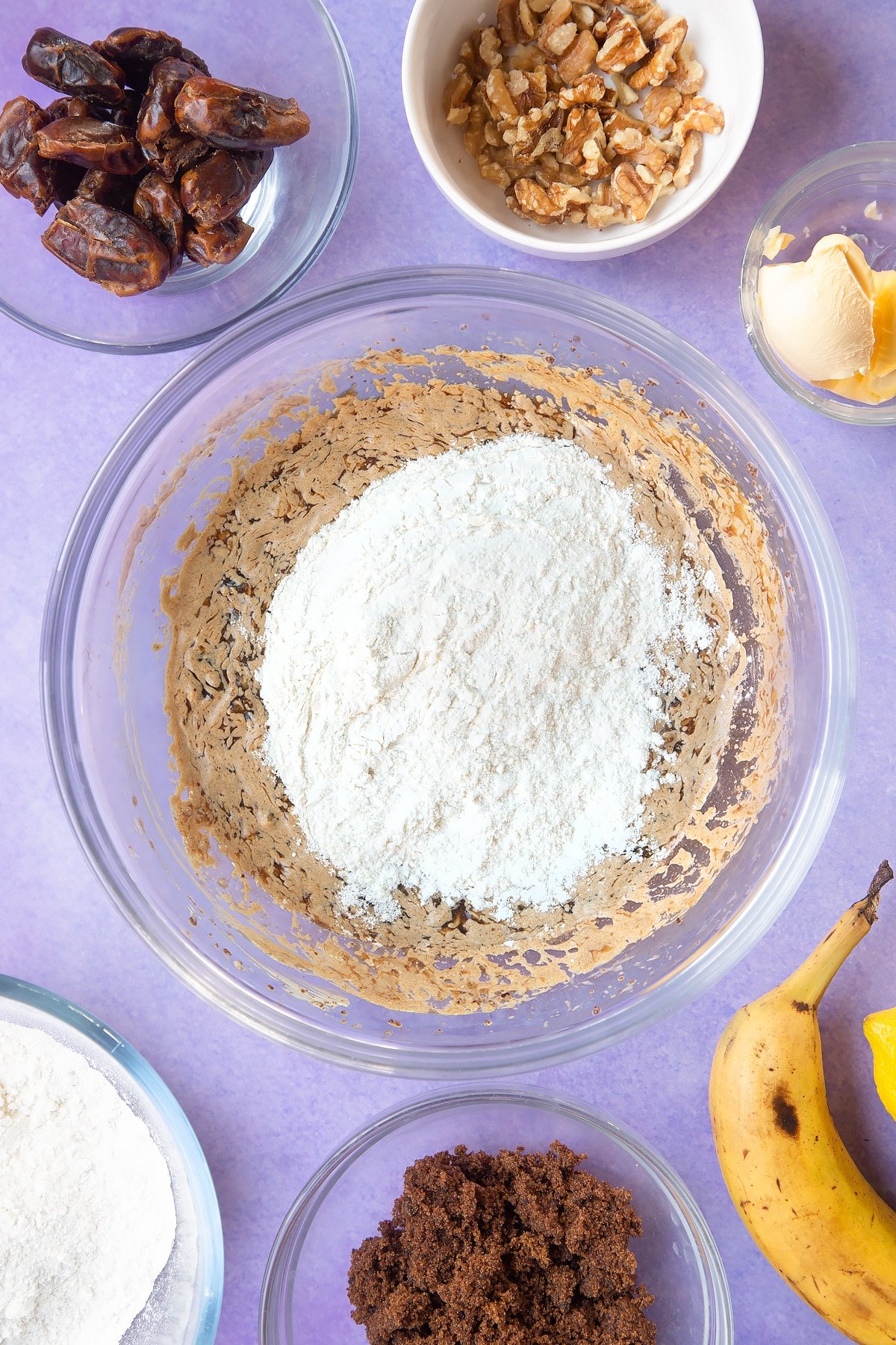 Overhead shot of soaked date mixture and banana mix in large bowl