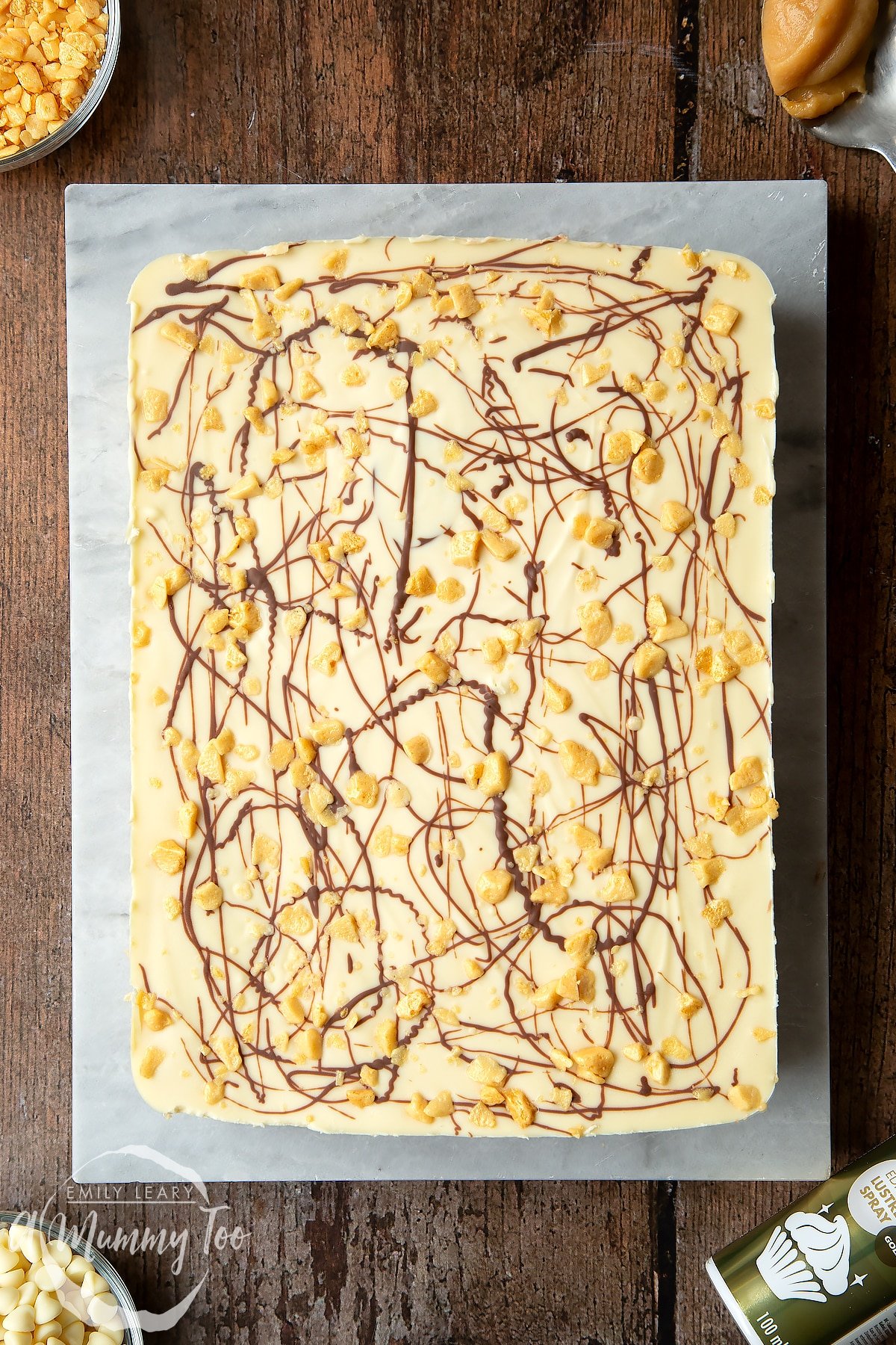 Overhead shot of the finished cake on a baking sheet on top of a dark wooden table. 