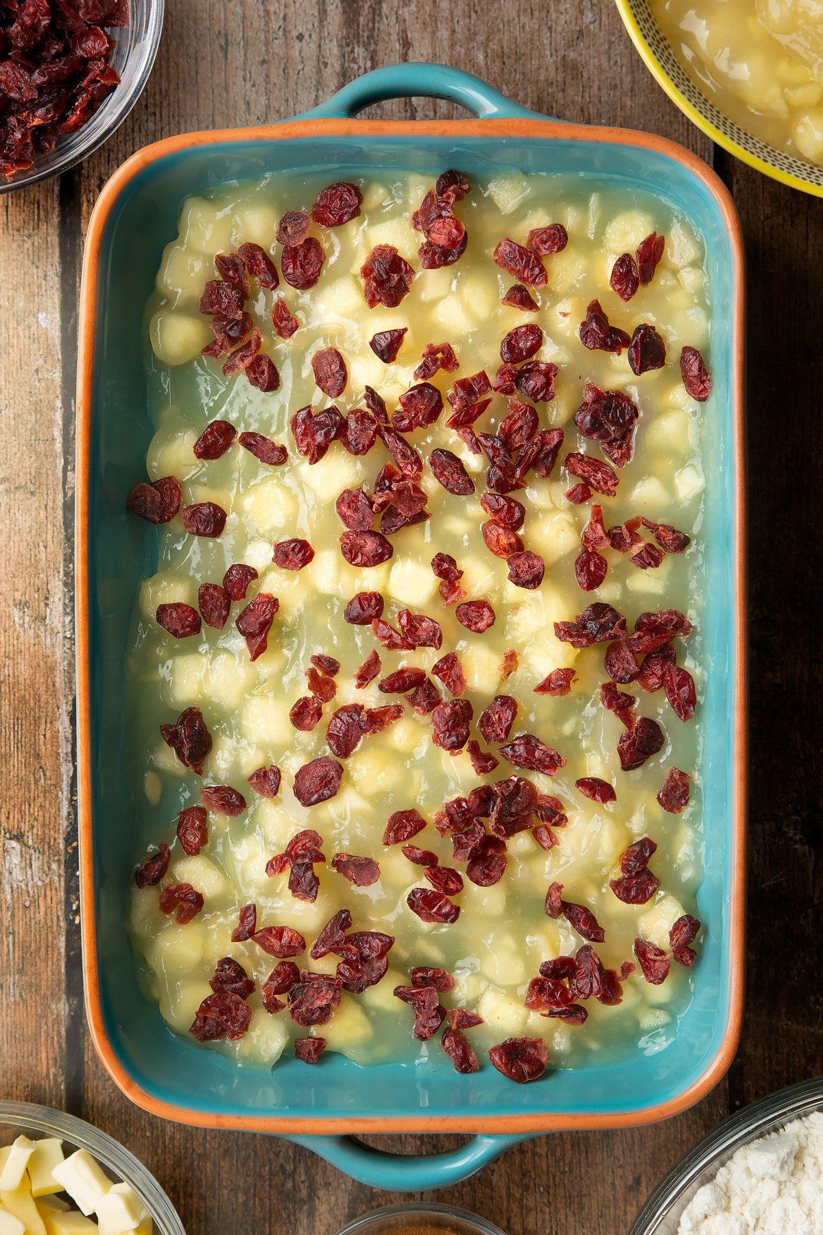 Tinned apple filling and dried cranberries in a roasting tray.