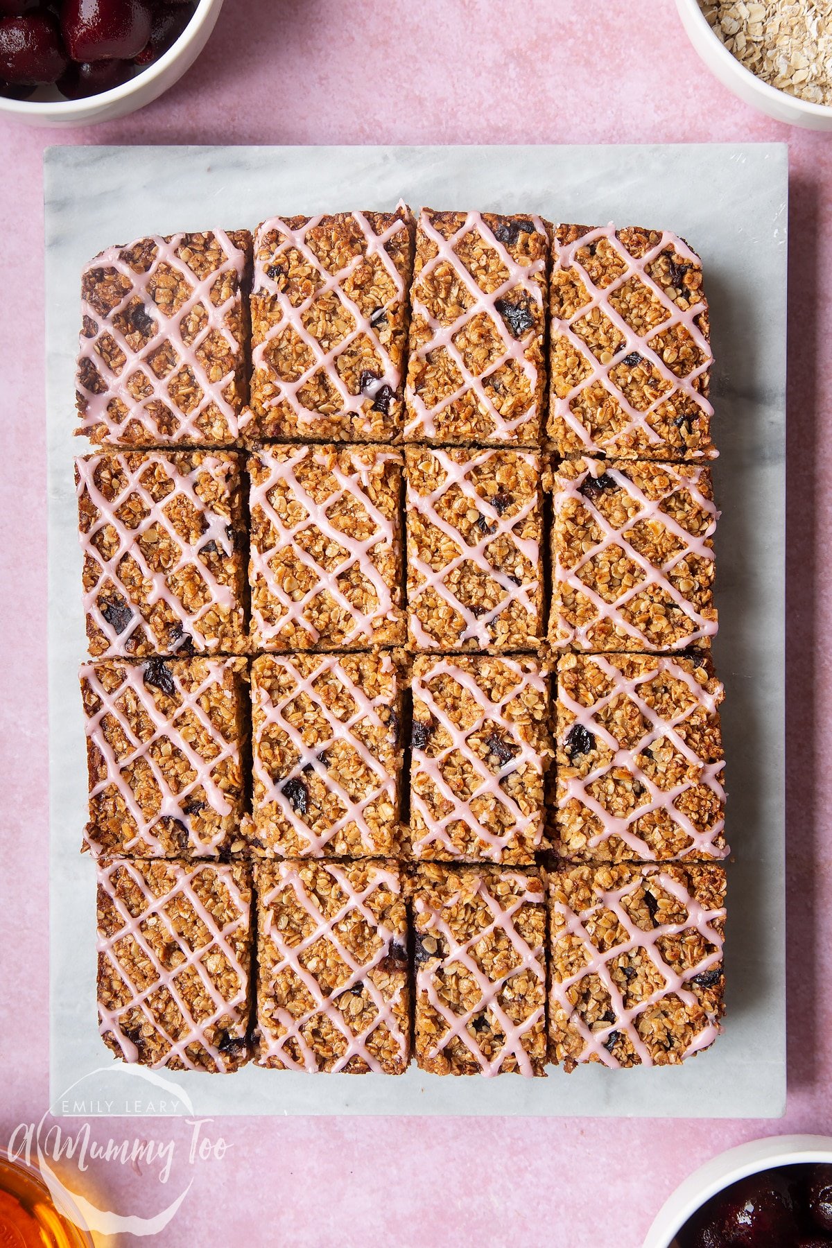 Overhead shot of Cherry flapjacks served on a marble slab with a mummy too logo in the lower-left corner