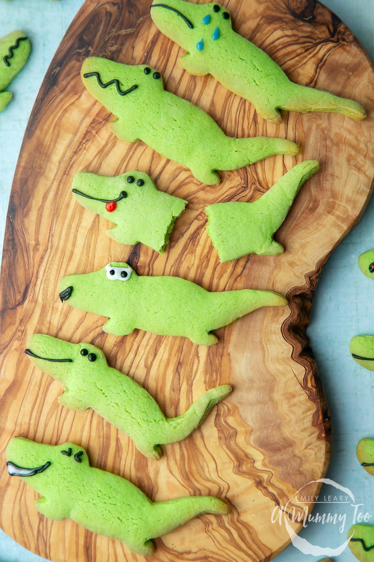 Finished crocodile cookies on a wooden board. 