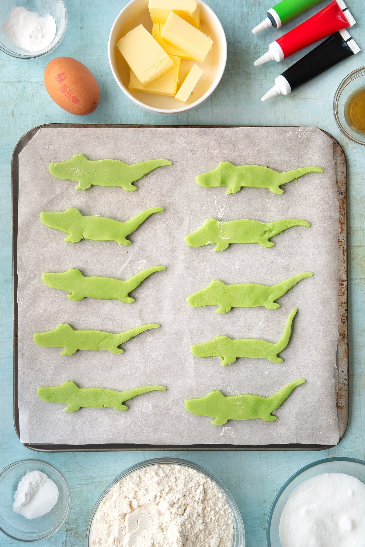 Cut out crocodiles made from pastry laid on a baking sheet. 