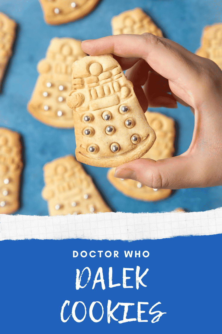 Dalek cookies decorated with silver candy balls. A hand holds one. Caption reads: Doctor Who Dalek cookies