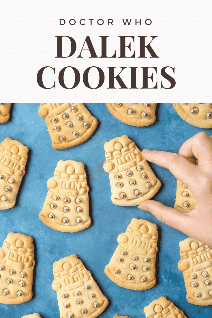 Dalek cookies decorated with silver candy balls. A hand reaches for one. Caption reads: Doctor Who Dalek cookies