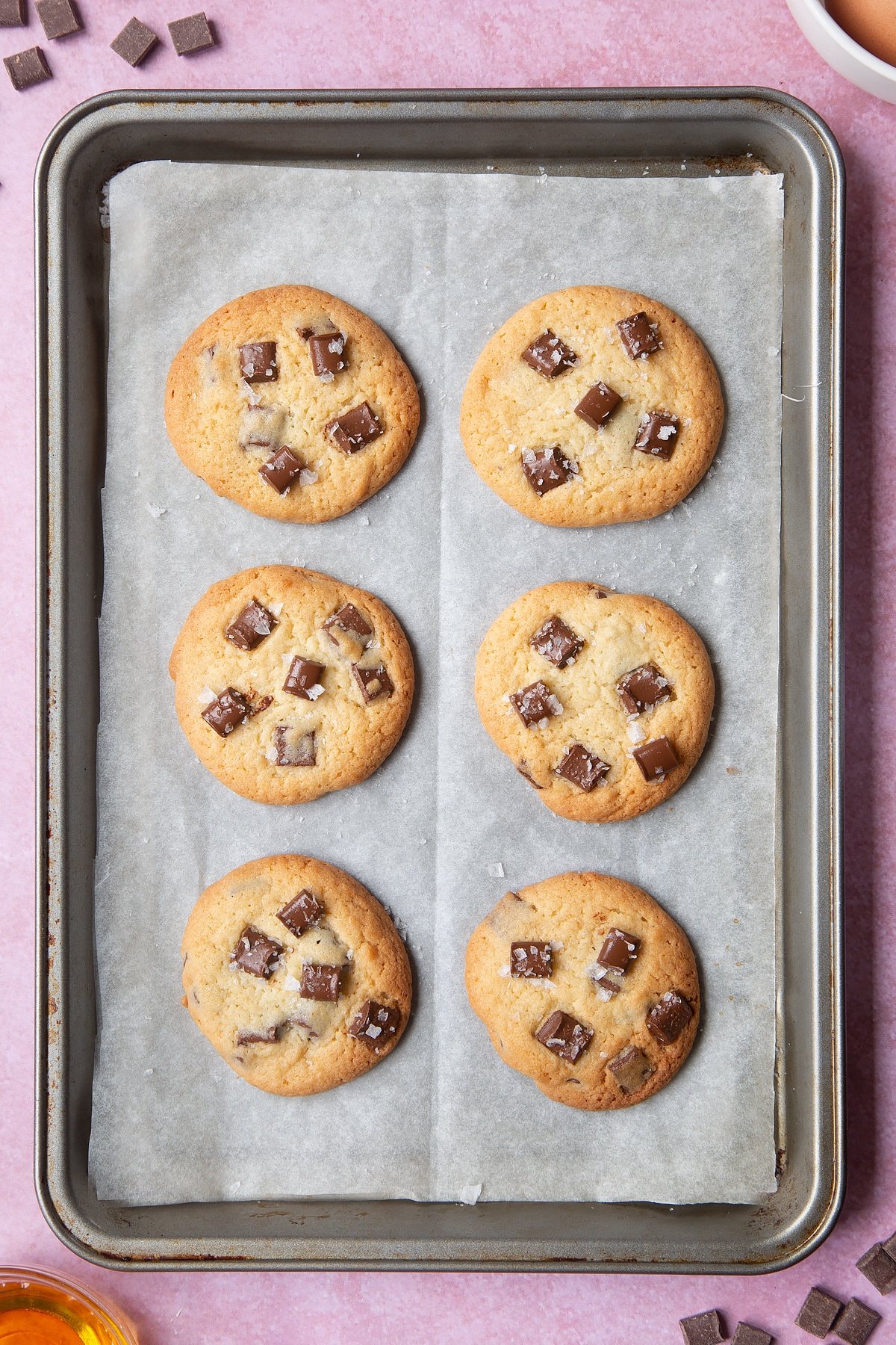 Overhead shot of Dark chocolate sea salt cookies with a mummy too logo in the lower-right corner