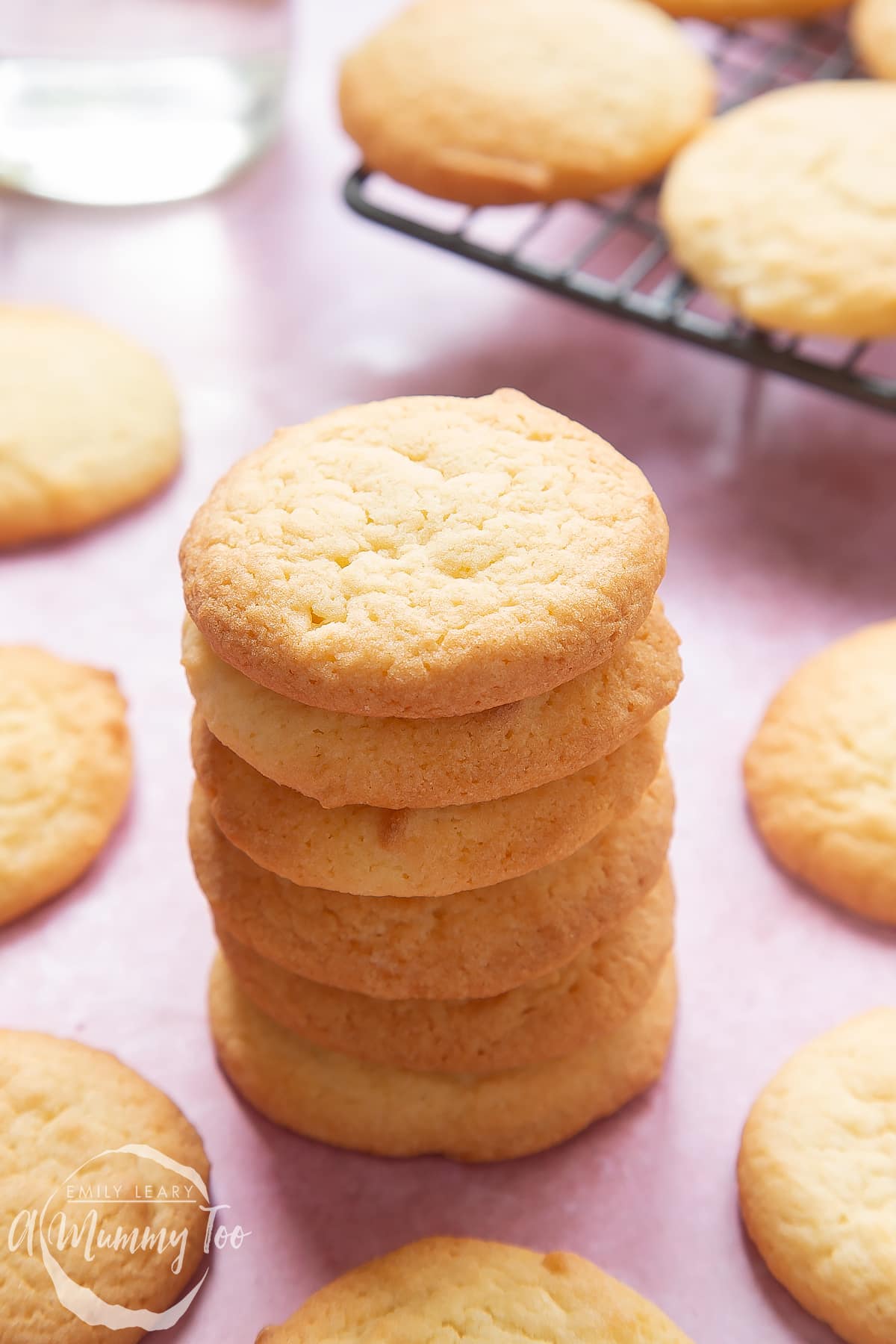 Overhead shot of sugar cookies stacked in a pile with a mummy too logo in the lower-left corner