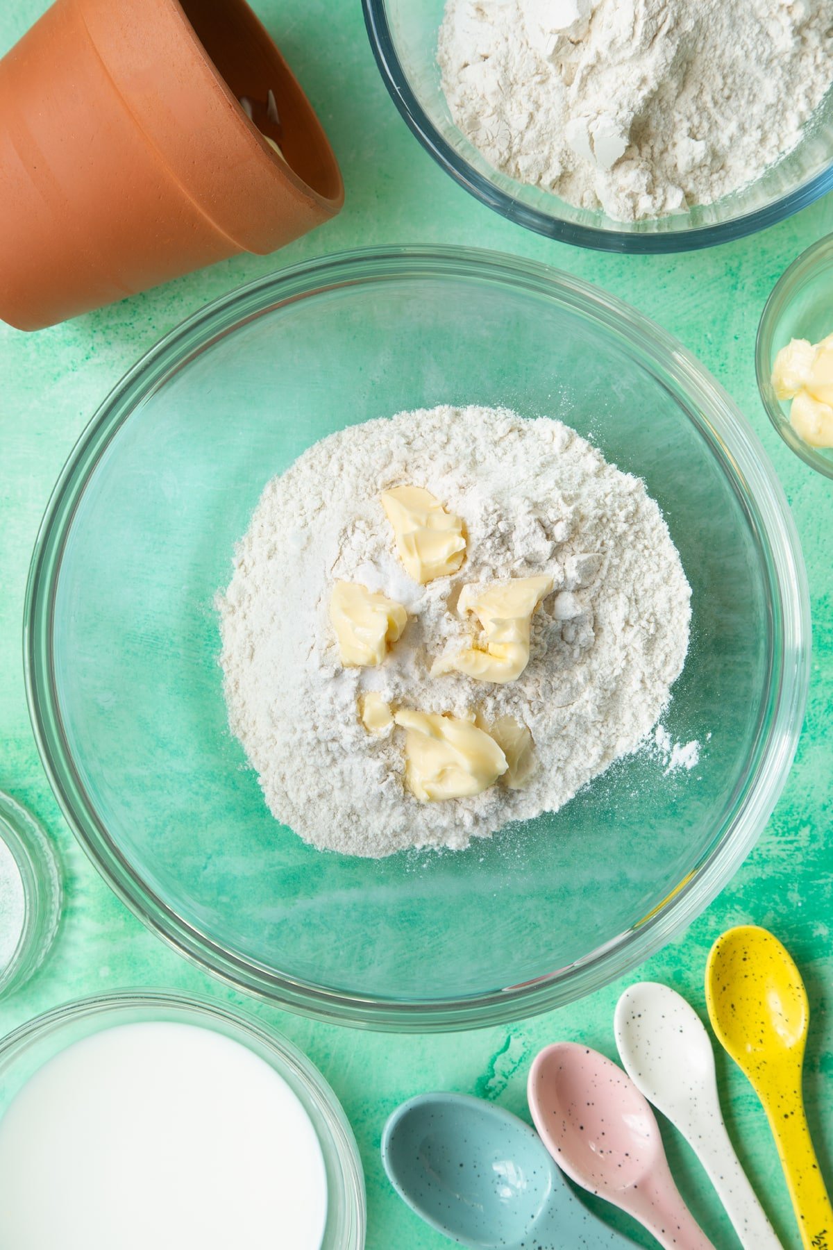 Overhead shot of flour and cold butter in a large bowl