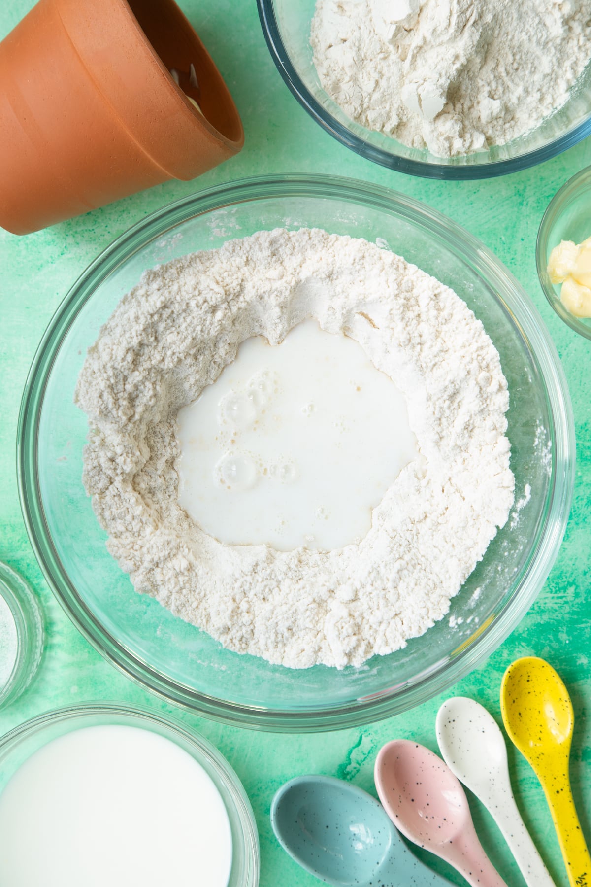 Overhead shot of flour with a hole in middle in a large bowl