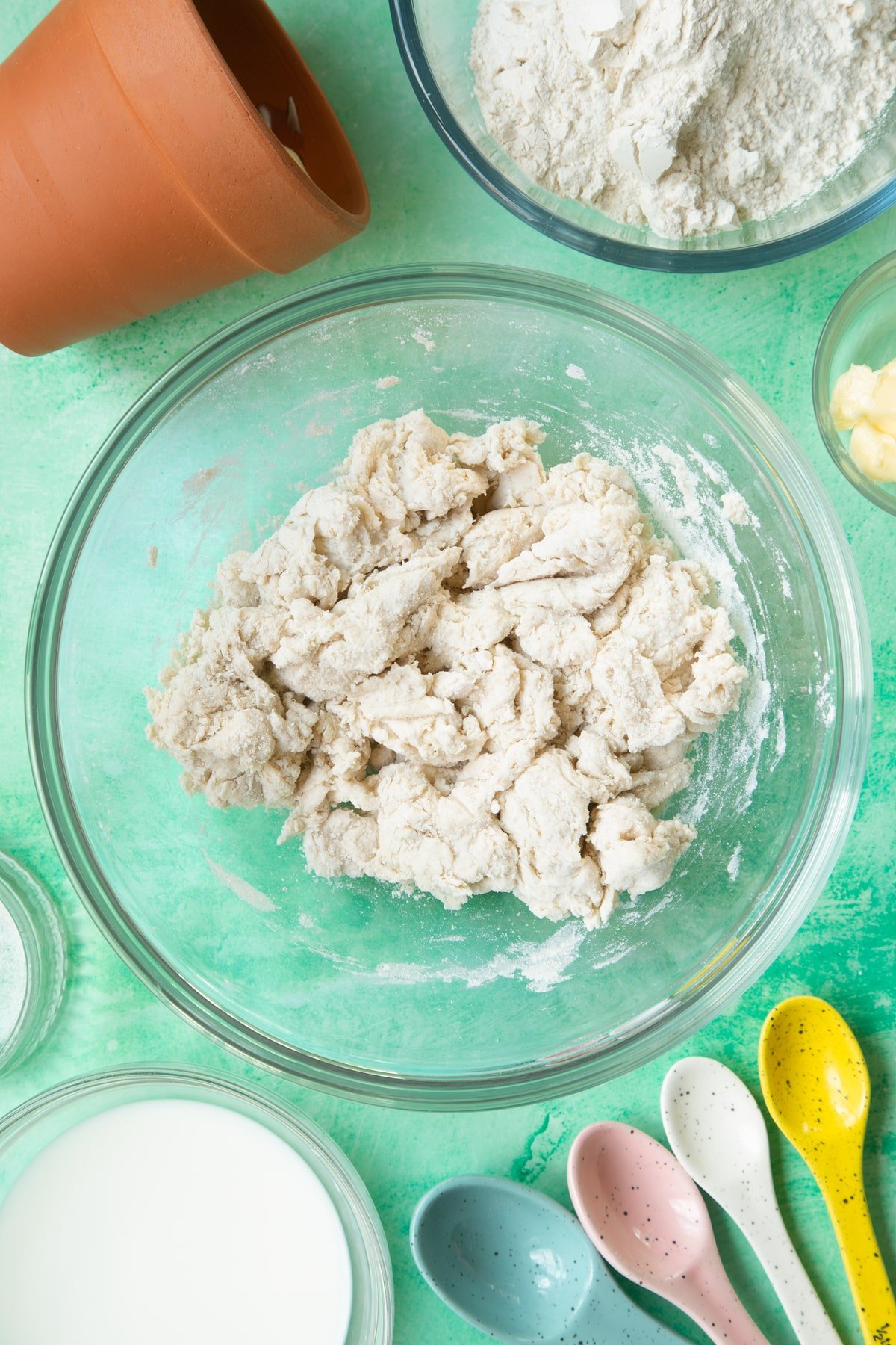 Overhead shot of the flowerpot bread dough in a clear bowl.