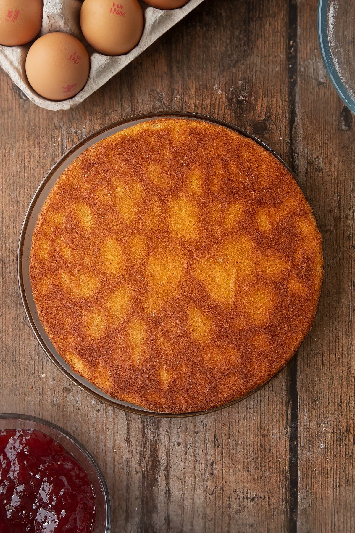 Overhead shot of Golden sponge cake on a wooden table. 