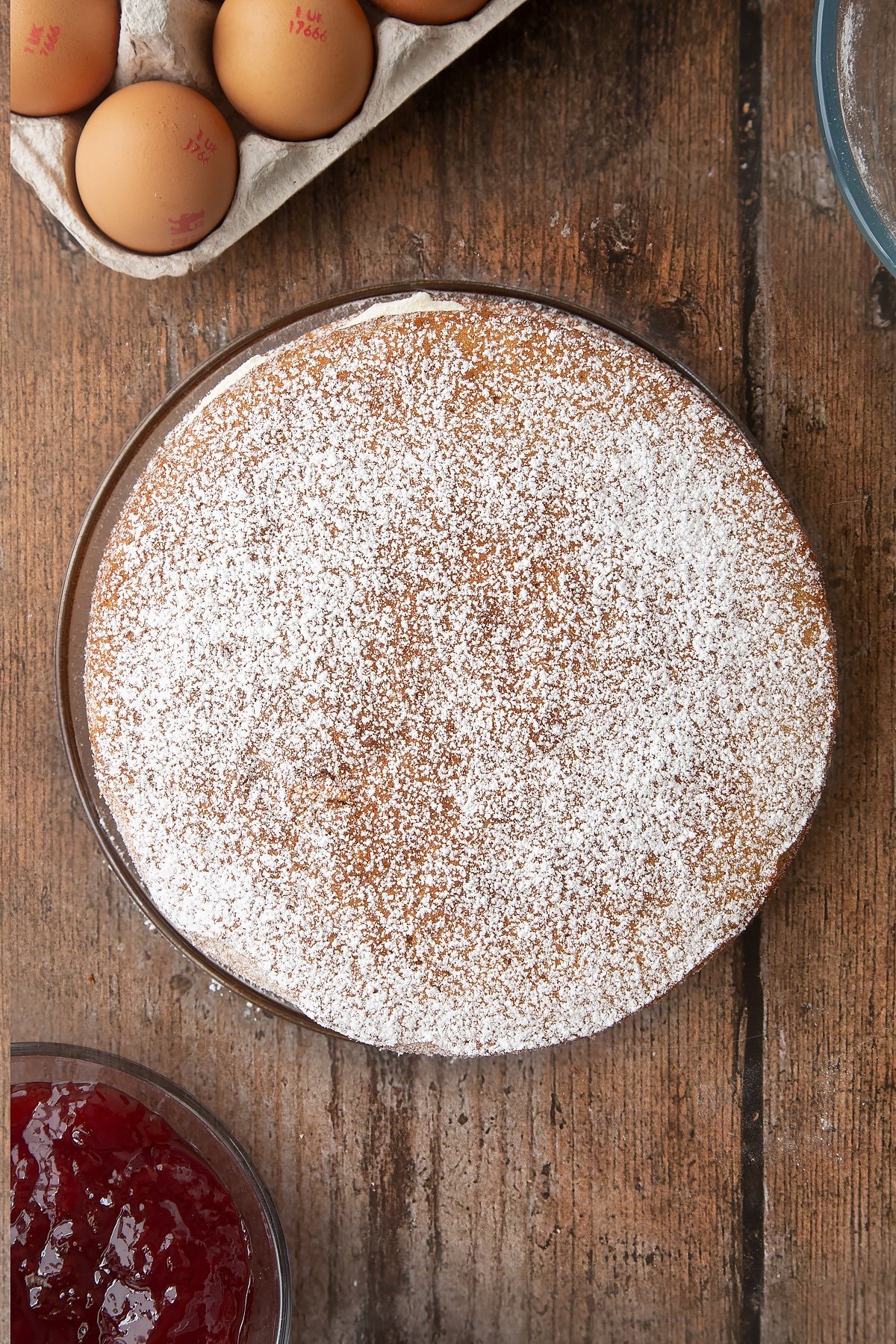 Overhead shot of the golden syrup sponge cake having been dusted with icing sugar. 