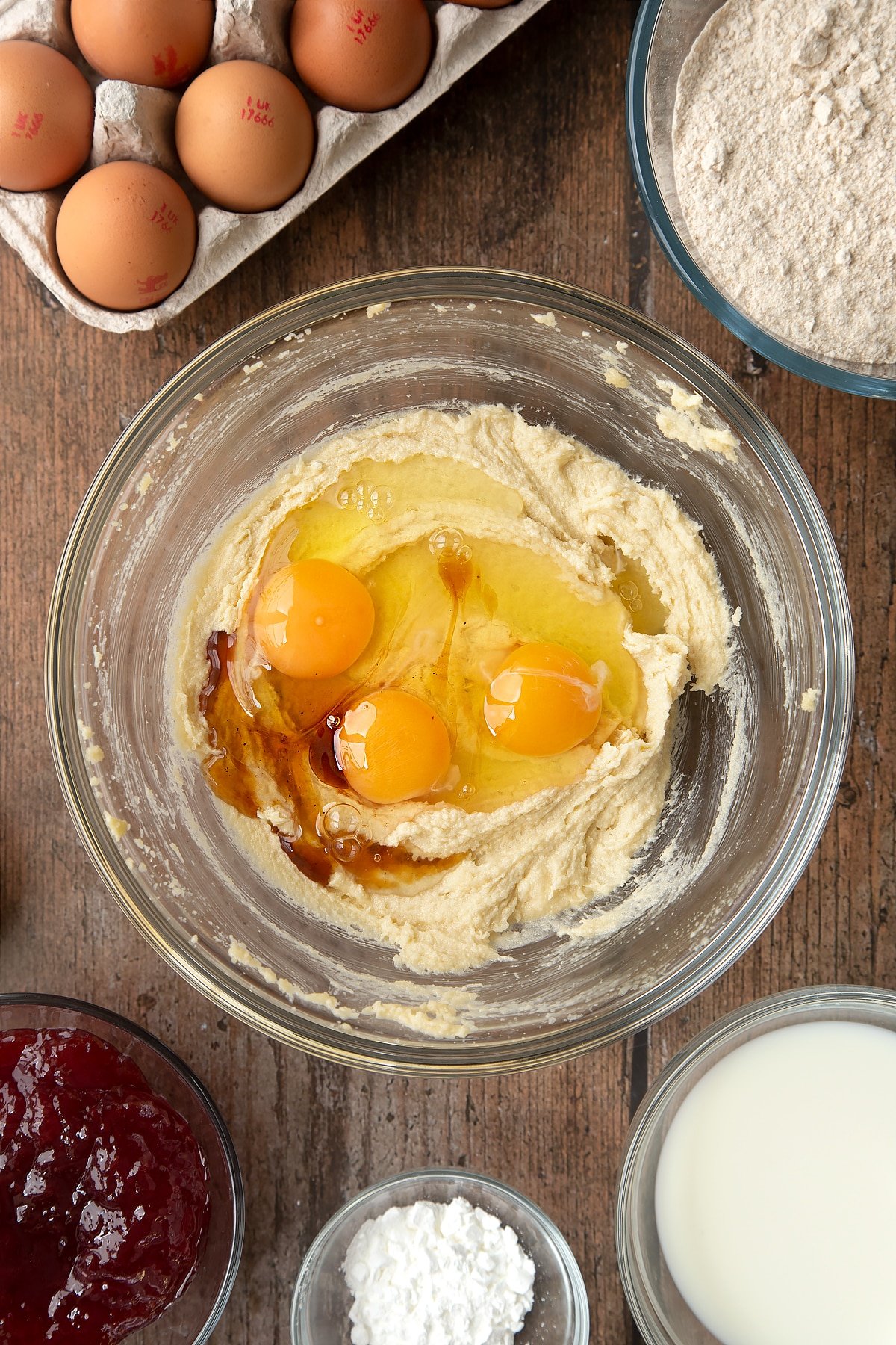 Overhead shot of buttermix and eggs in a mixing bowl