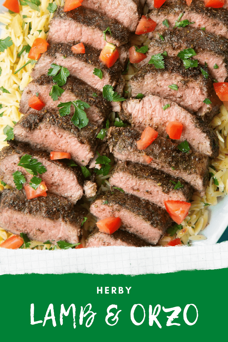 Slices of herby lamb arranged on a bed of orzo on an oval platter. Caption reads: herby lamb & orzo